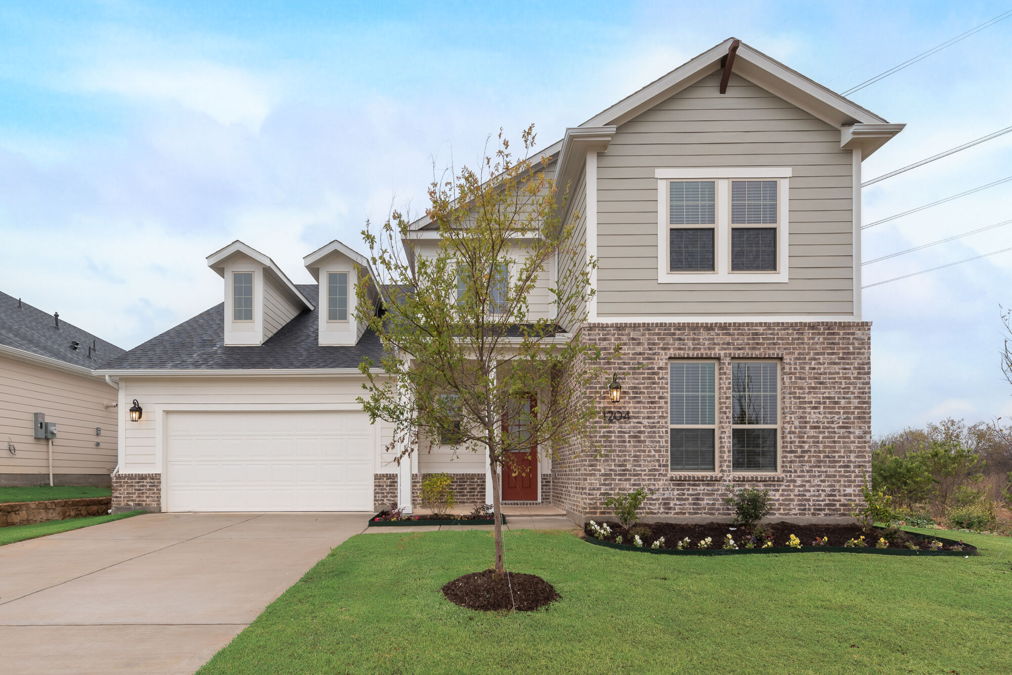 Elevation Front with garage, window, exterior brick and siding