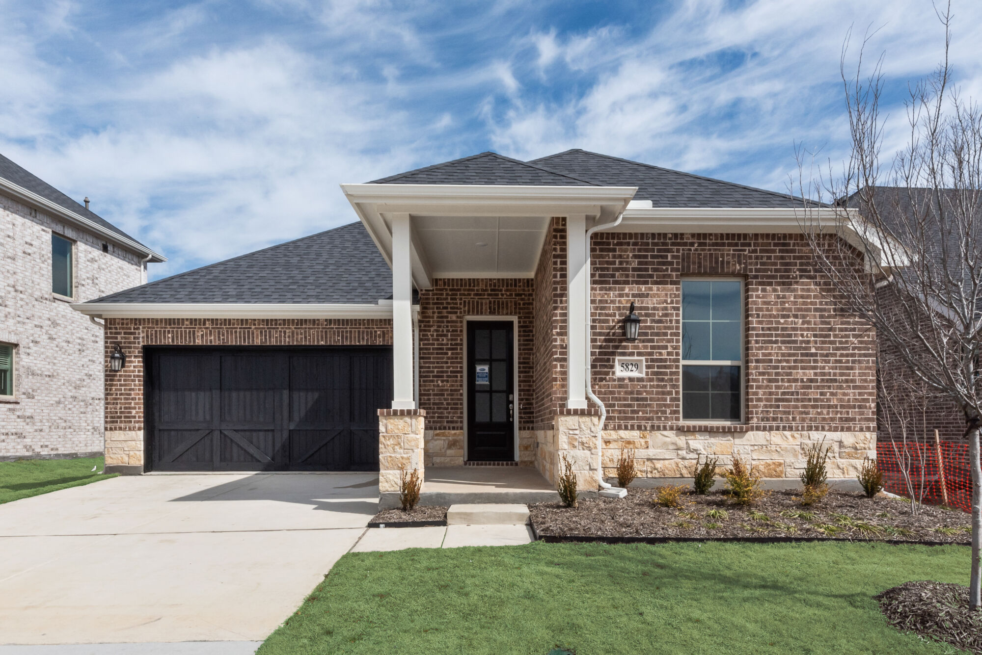 Elevation Front with window, garage, door, exterior brick and exterior stone