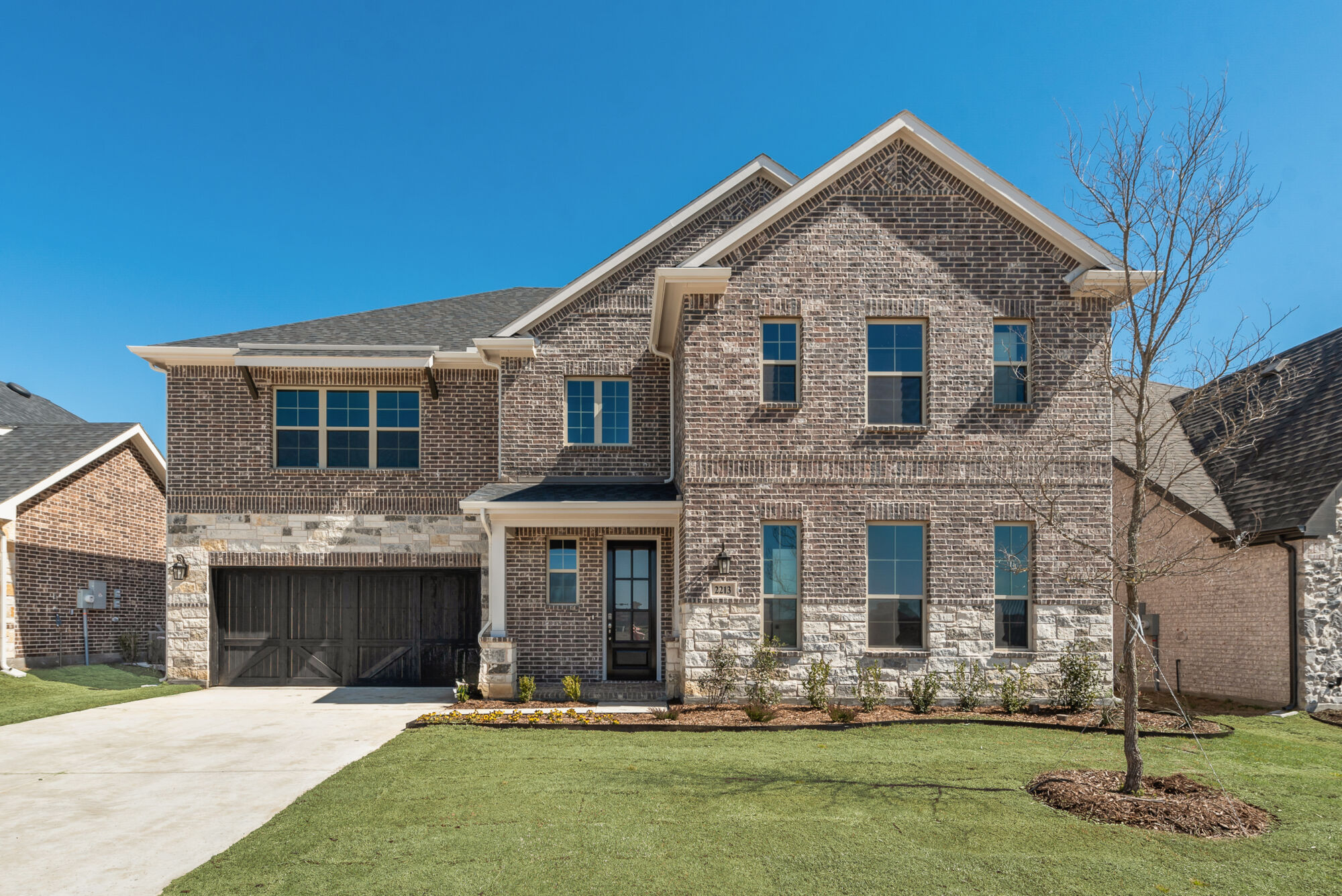 Elevation Front with garage, window, exterior brick, door and exterior stone