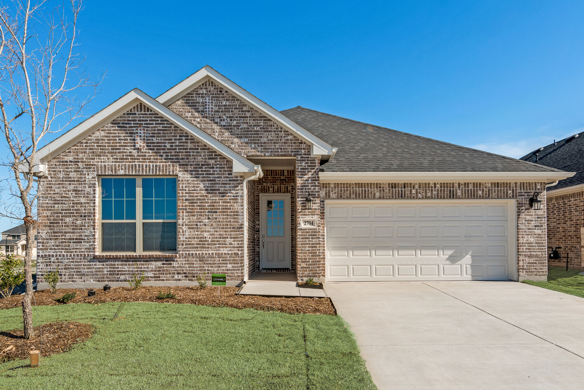 Elevation Front with garage, door, window and exterior brick