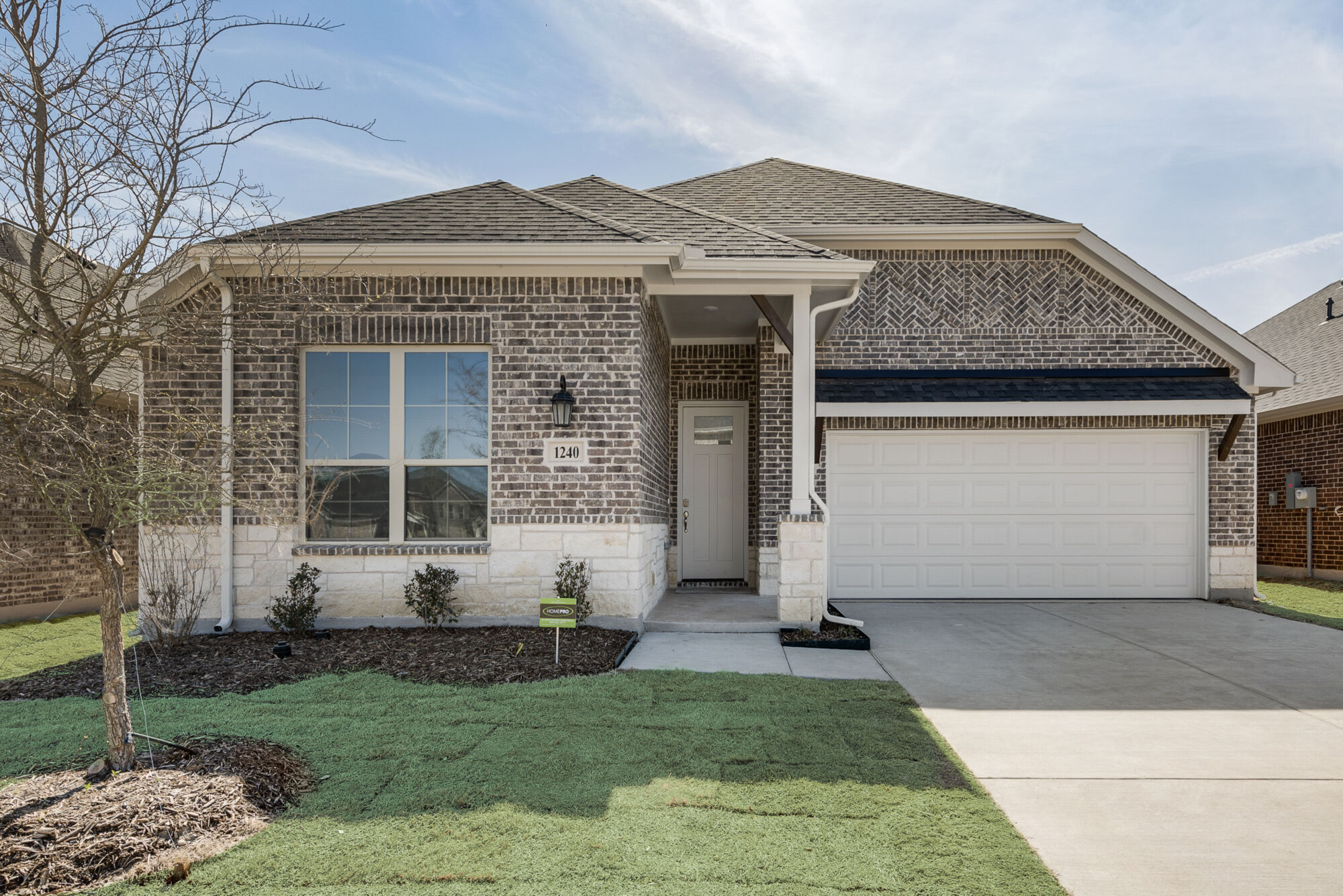 Elevation Front with window, garage, door, exterior brick and exterior stone