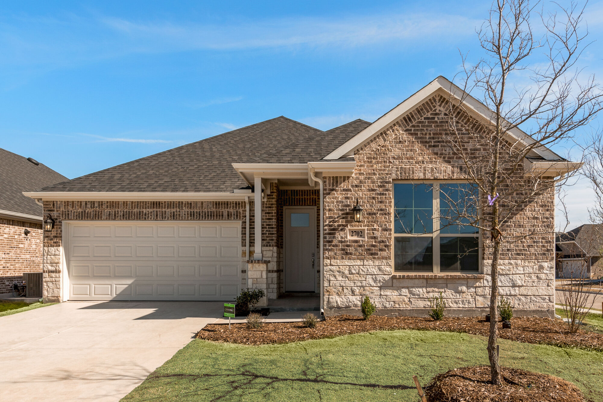 Elevation Front with window, garage, door and exterior brick