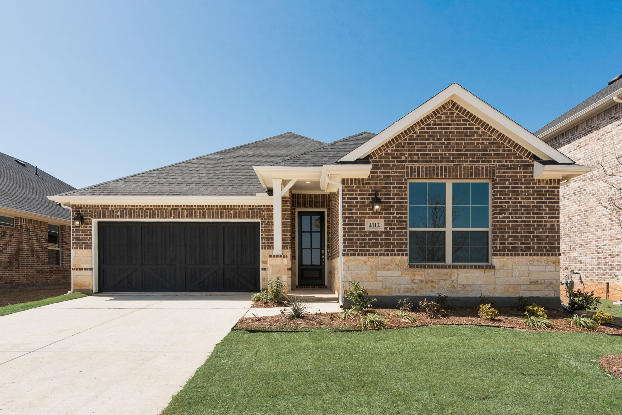 Elevation Front with garage, window, door and exterior brick