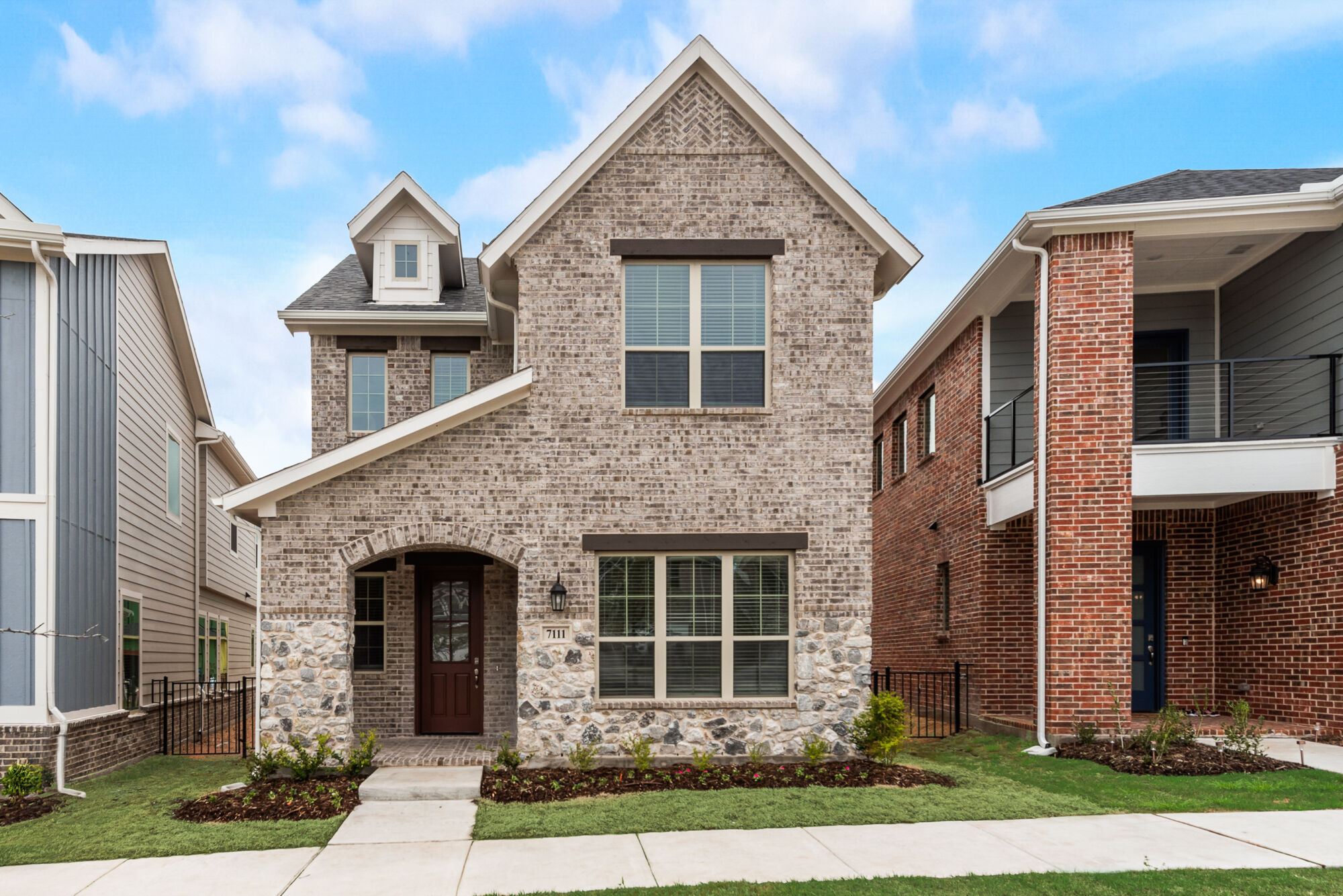 Elevation Front with window, door, exterior stone and exterior brick