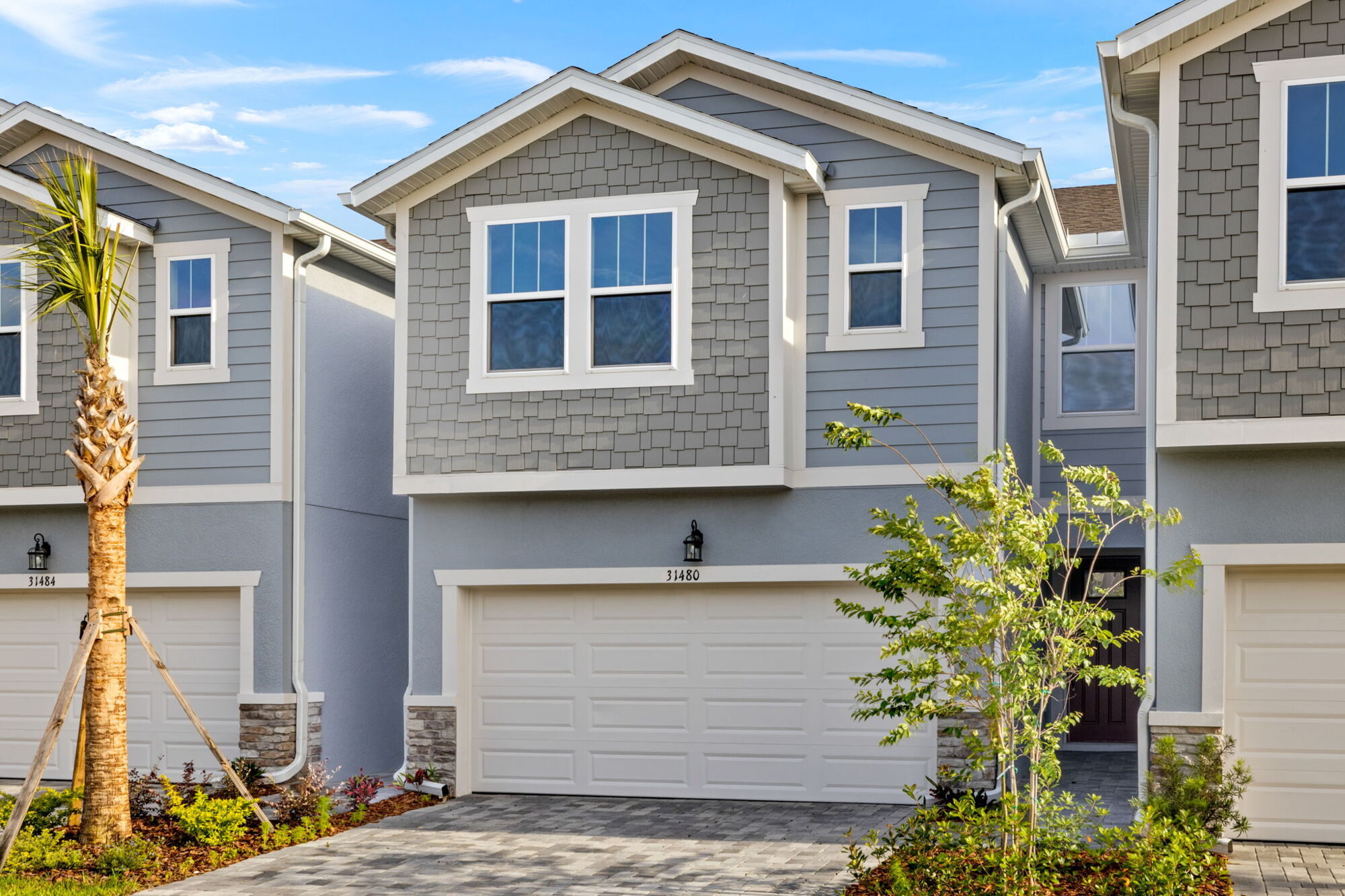 front of home, shake and hardi plank exterior, garage door, paver drive