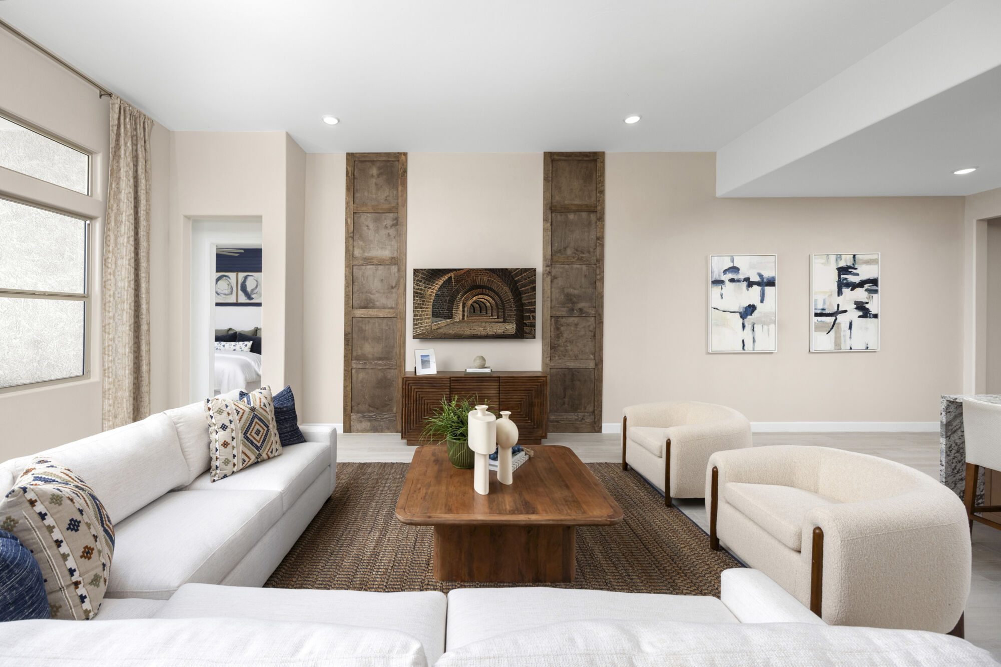 Greatroom with sectional couch, coffee table, wood wall decor