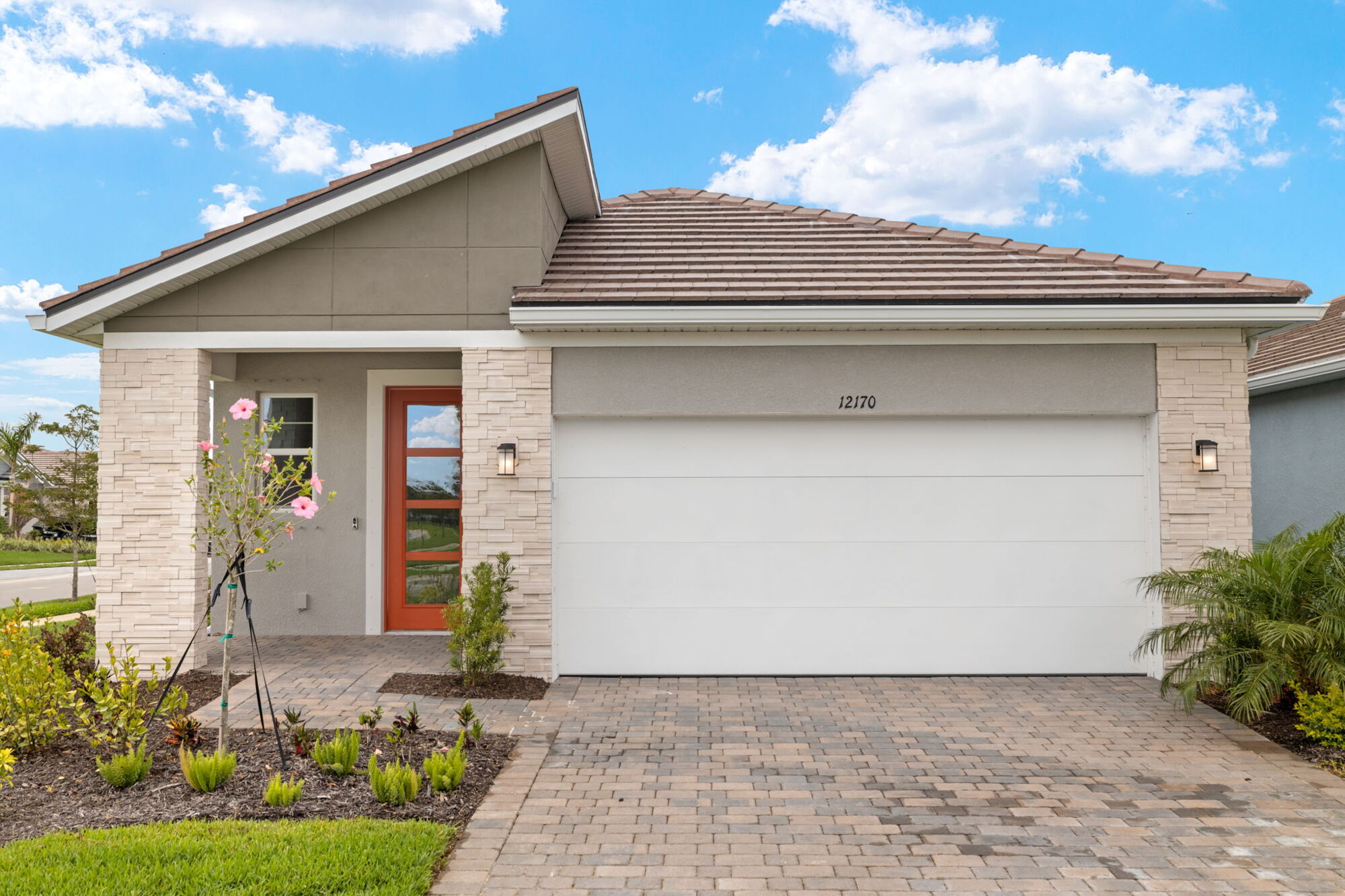 3 bedroom, powder room, 2 bath, open floor plan, stainless steel appliances, tile floors, island with breakfast bar, white shaker cabinets, oversized glass sliders, covered lanai with pavers,  windows in dining, 