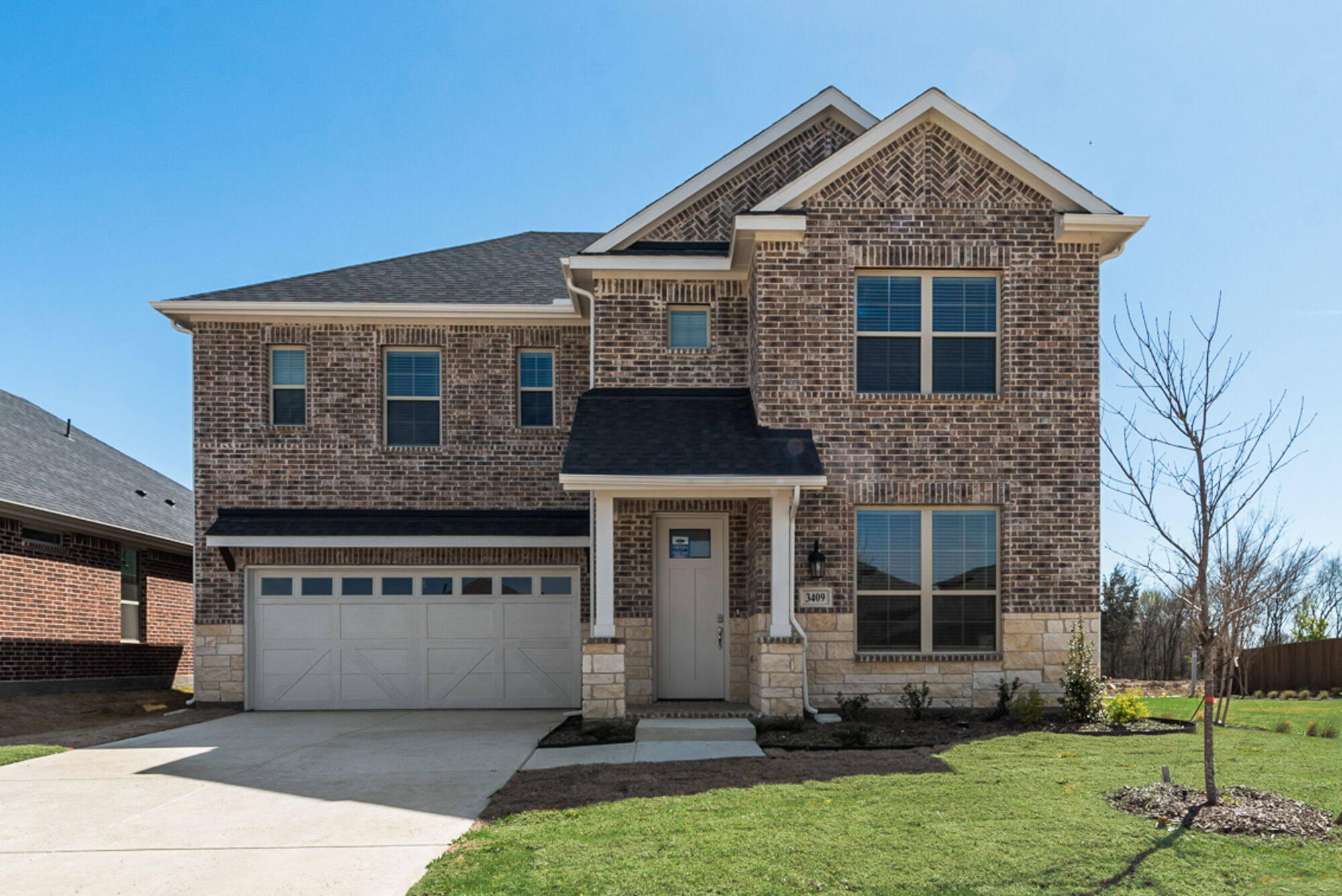 Elevation Front with window, garage, exterior brick, door and exterior stone