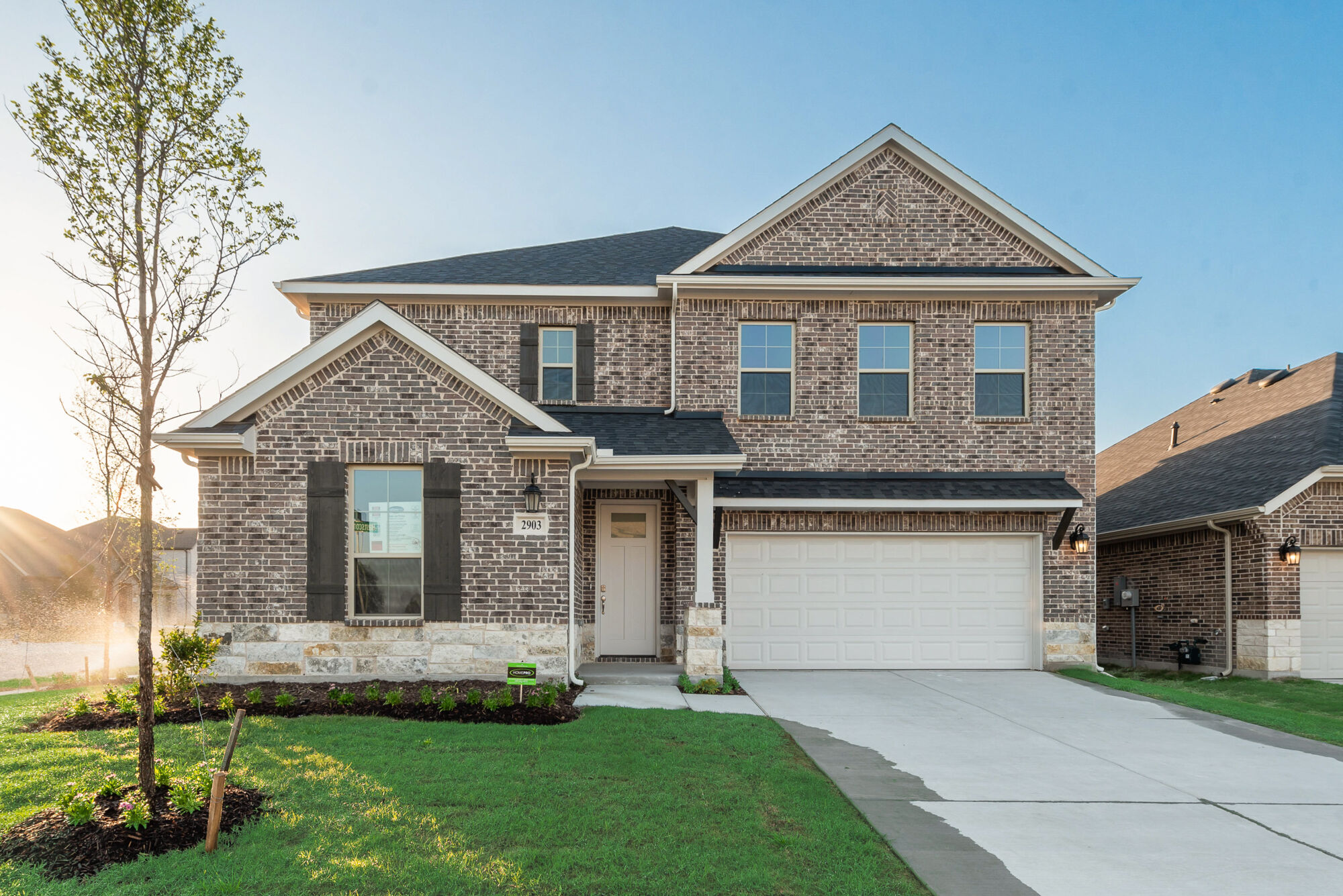Elevation Front with window, garage, exterior brick and exterior stone