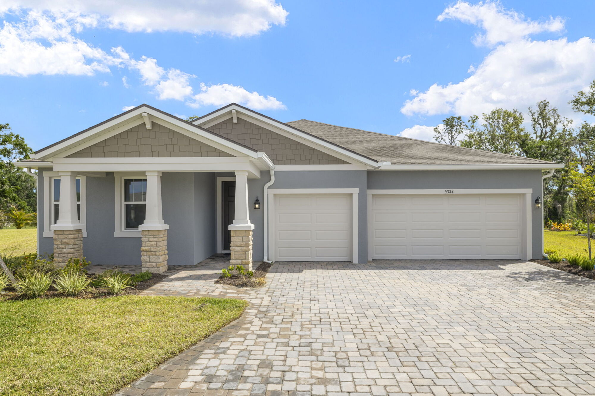  Elevation Front with garage, window, stone flooring and door