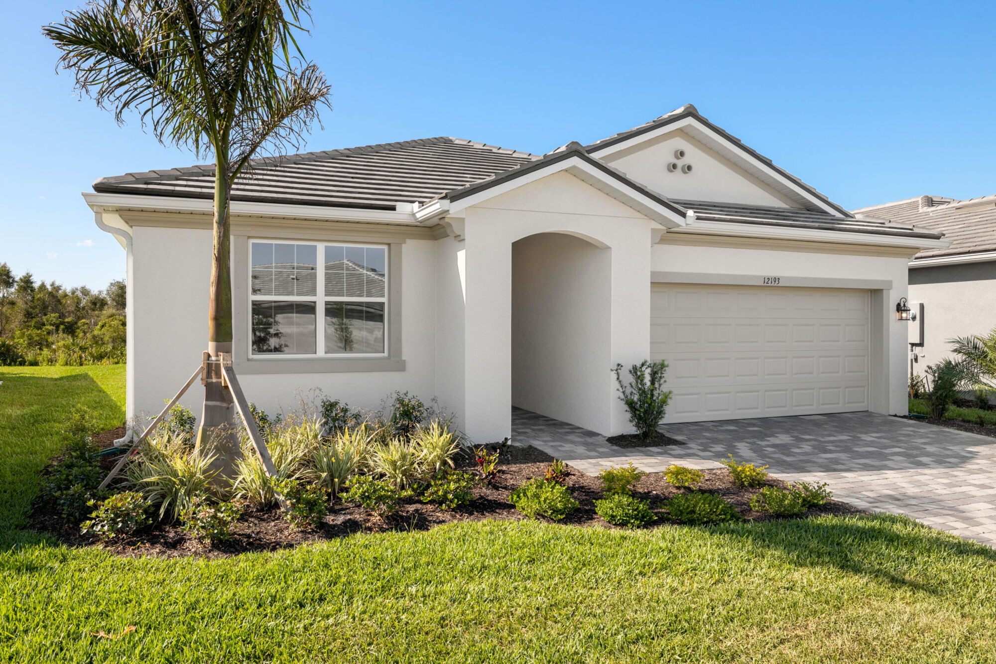 brown and tan plank tile flooring, light shaker cabinets, light quartz countertops, LED lights, washer and dryer included, walk-in closet with racks, glass enclosed shower, oversized glass sliding doors, open concept floor plan
