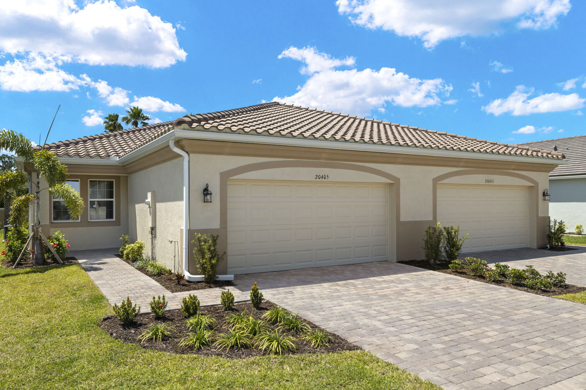 Spanish exterior, paver driveway, tile roof, garage door