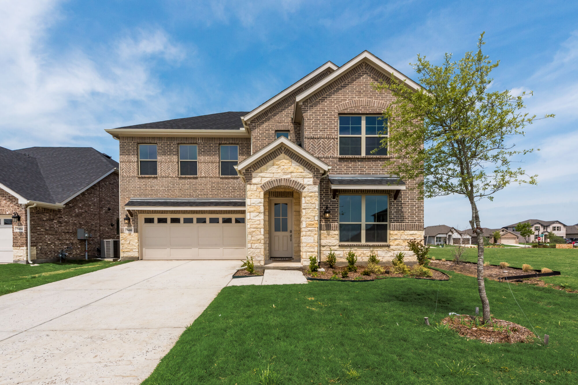 Elevation Front with window, garage, door, exterior brick and exterior stone