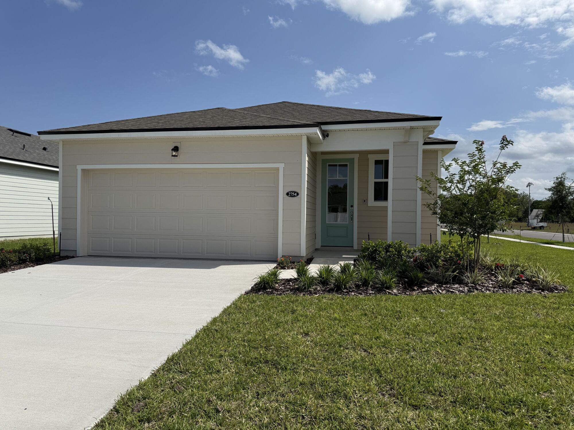  Elevation Front with garage, door, window and exterior clapboard