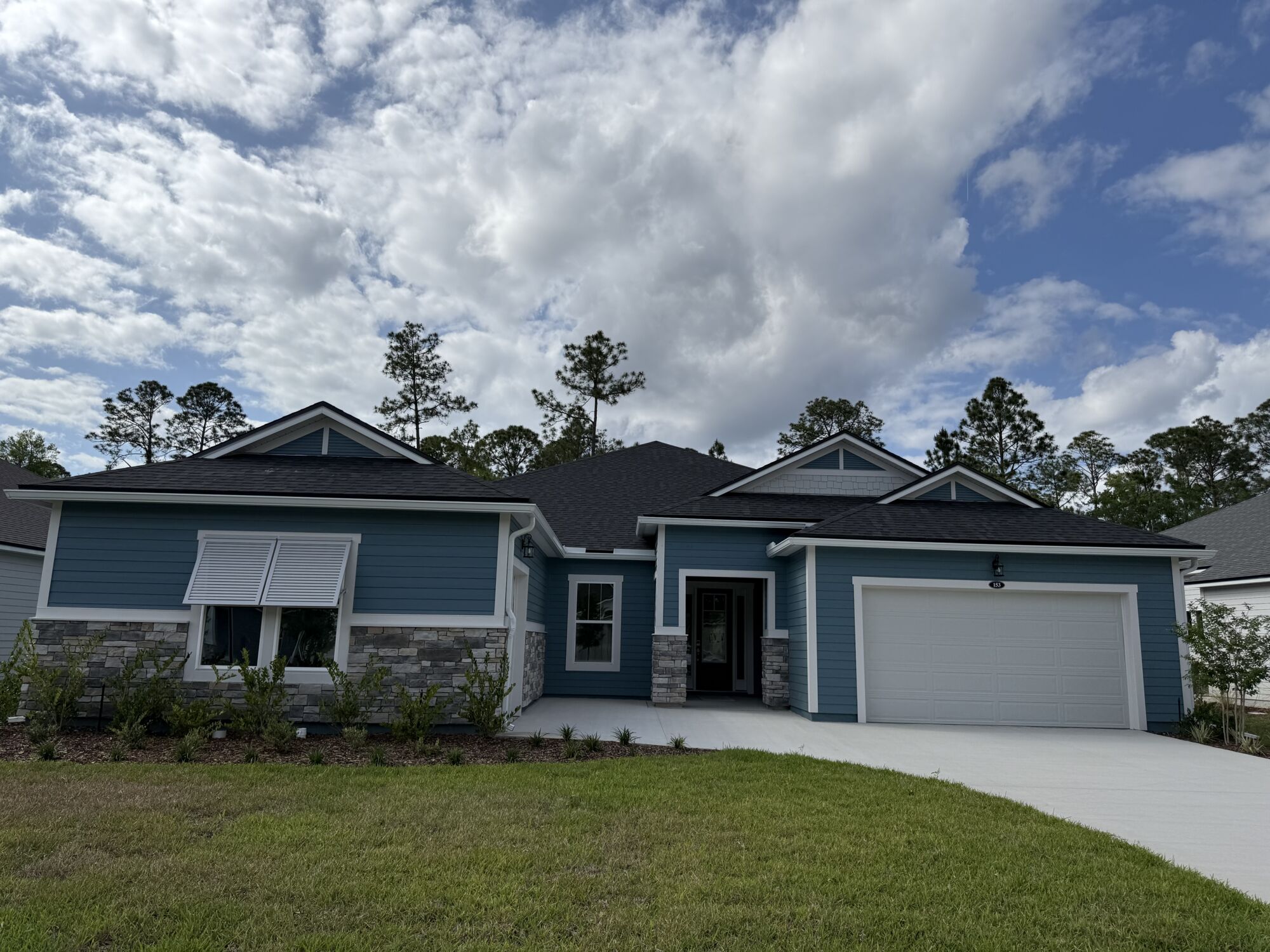 Elevation Front with garage, window, door and exterior stone