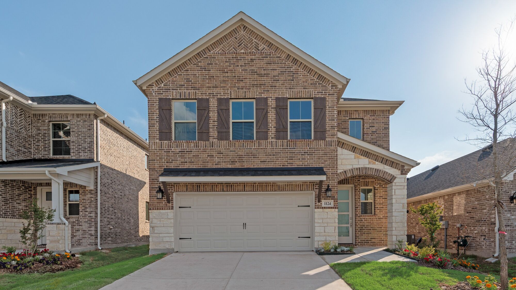 Elevation Front with window, garage, exterior stone and exterior brick