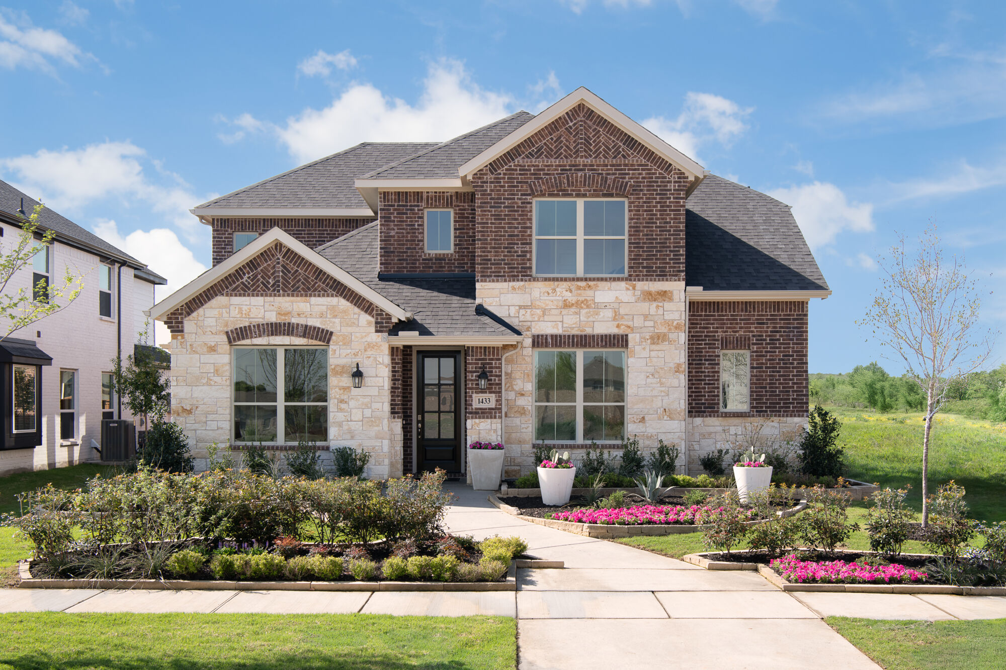 Elevation Front with window, door, exterior brick and exterior stone