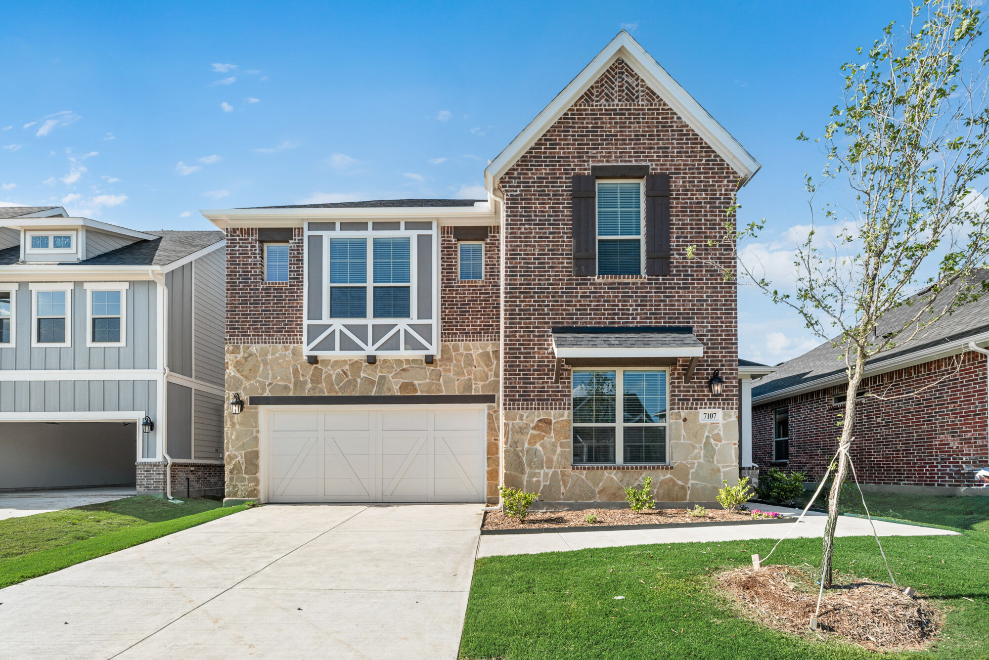 Elevation Front with window, garage, exterior brick and exterior stone