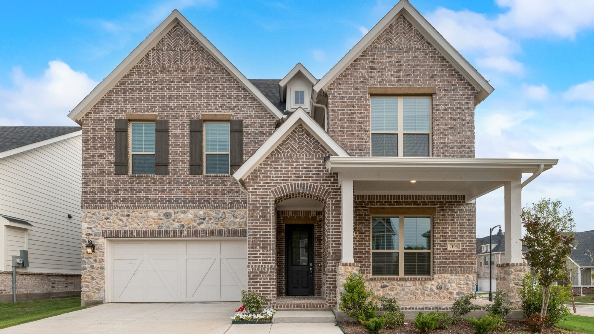Elevation Front with window, garage, exterior brick, exterior stone and exterior clapboard