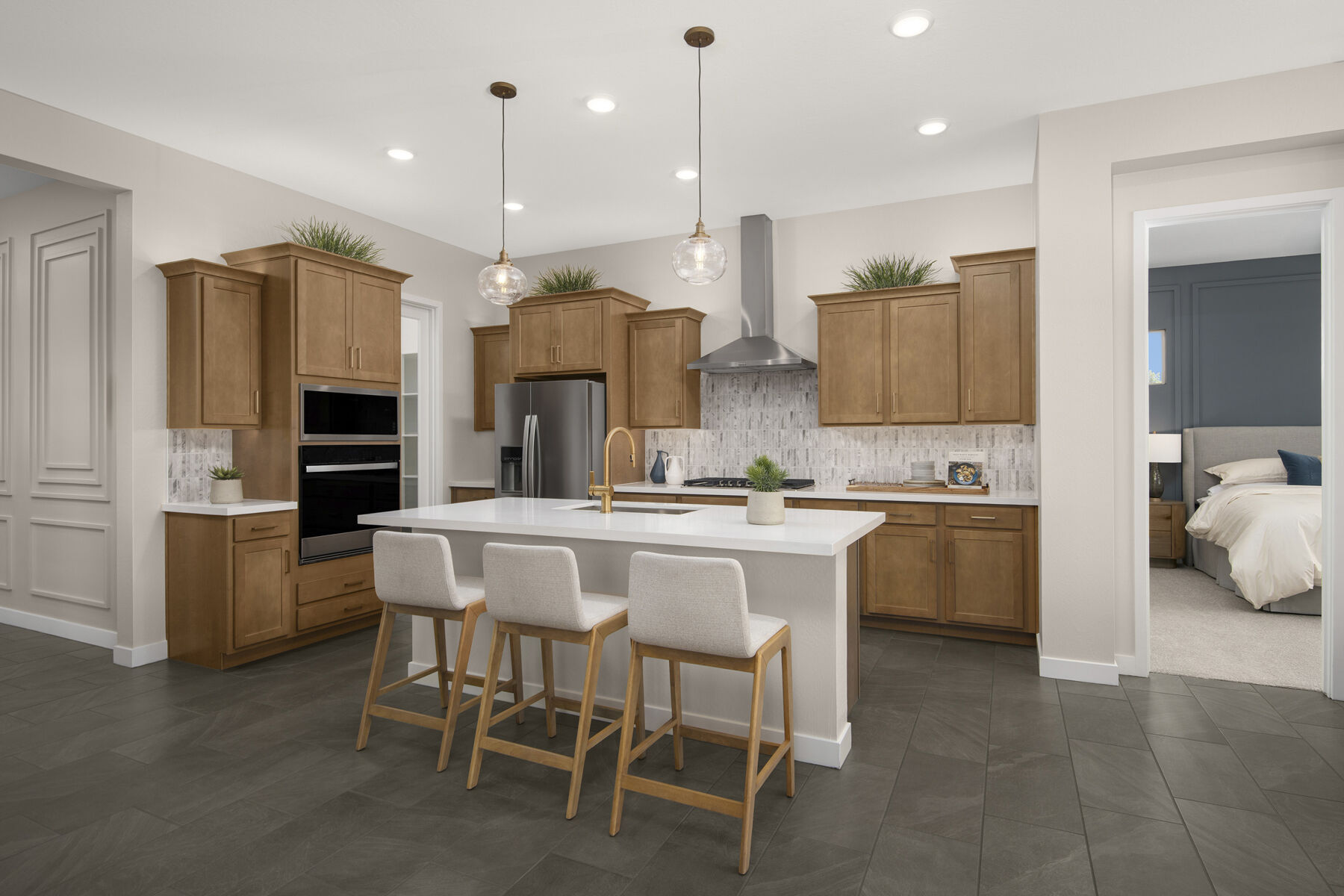 L-Shaped Kitchen with oven, pendant light, carpet, refrigerator, tile flooring and light wood cabinets
