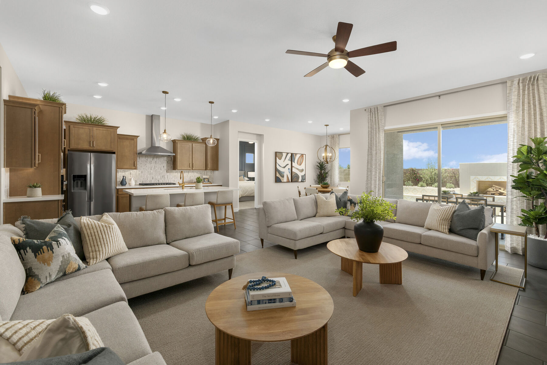  Greatroom with refrigerator, painting, curtains, window, pendant light, door, rug, light wood cabinets and carpet