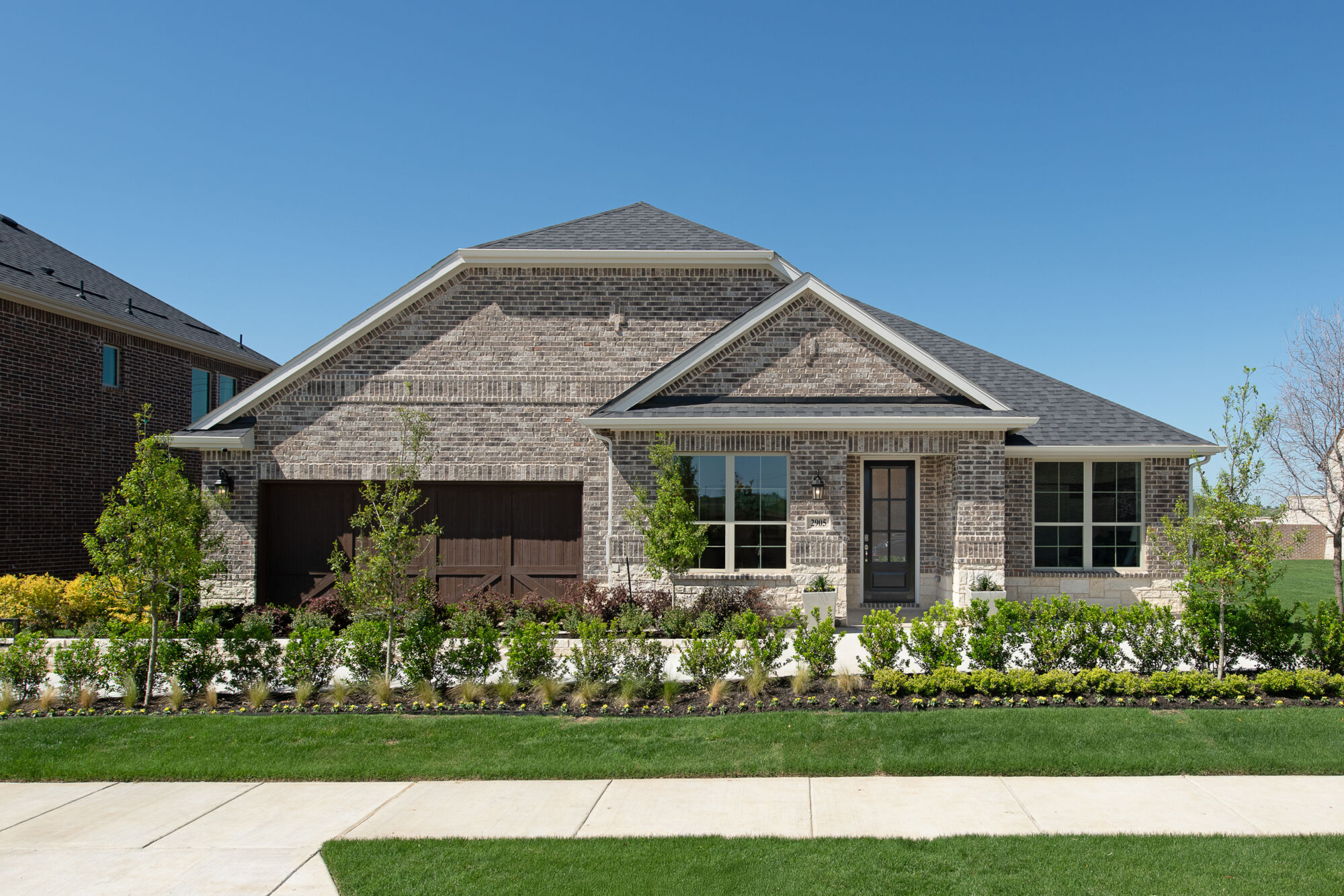Elevation Front with window, door, garage and exterior brick