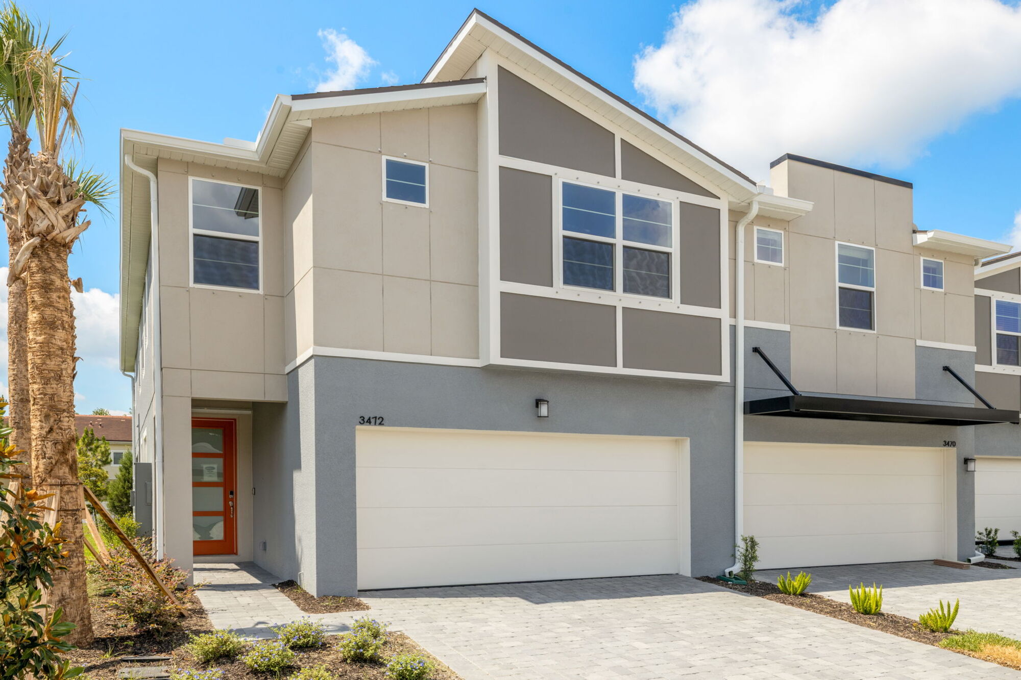 modern exterior, paver drive, 2 car garage, townhome, 4 bedrooms, 3 baths, screened lanai, open concept, water view, quartz countertops, painted cabinets