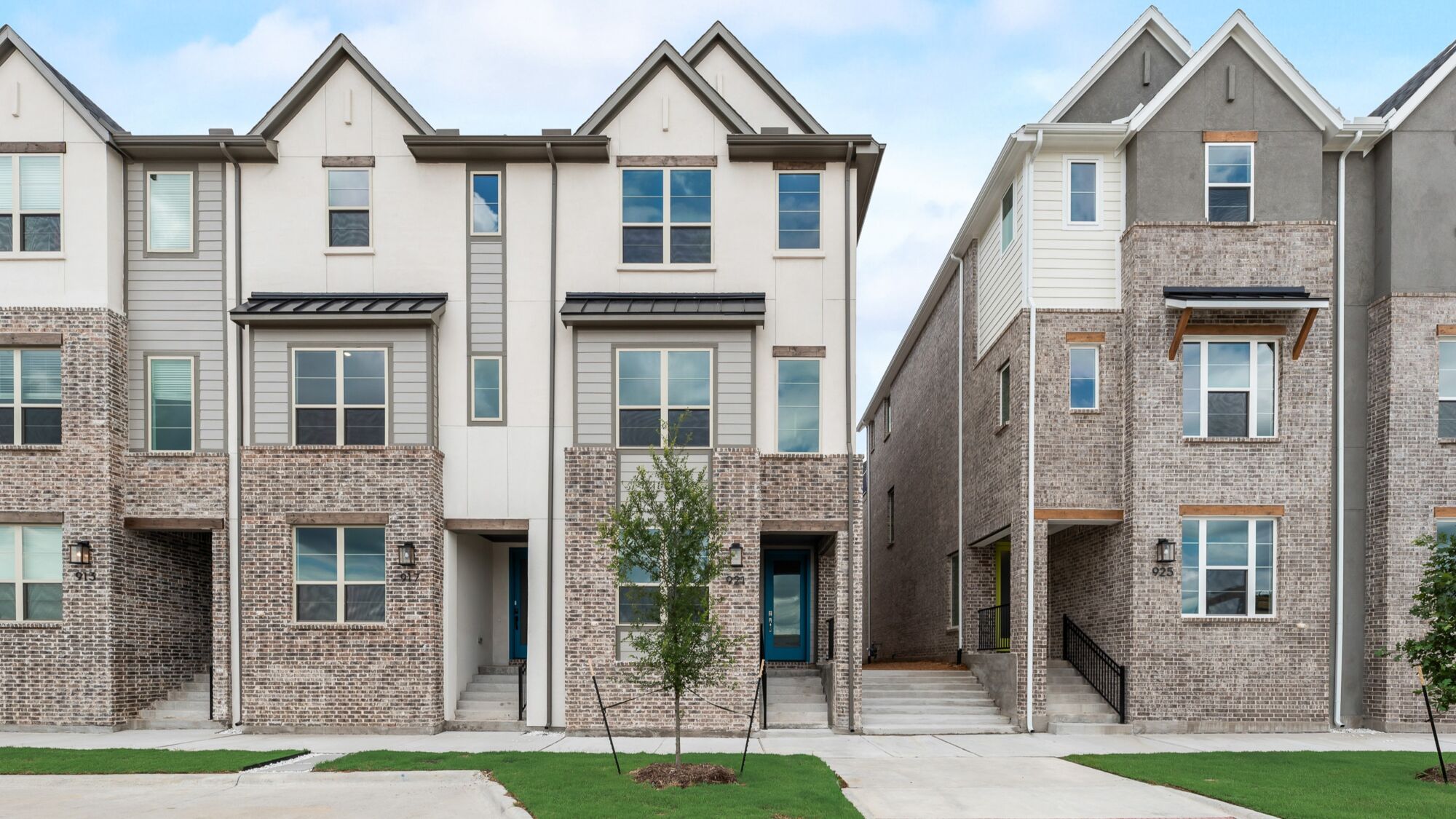 exterior of three story townhomes with brick facade