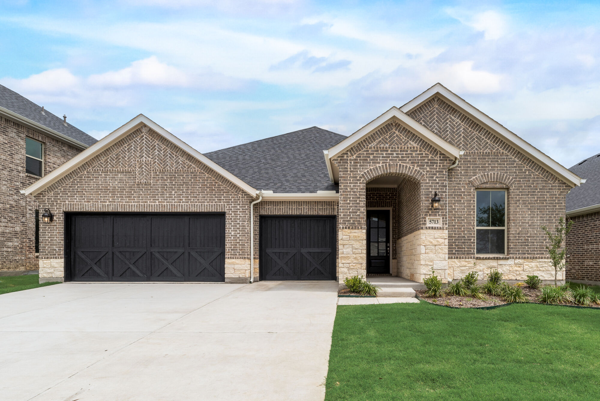 Elevation Front with garage, window, door, exterior stone and exterior brick