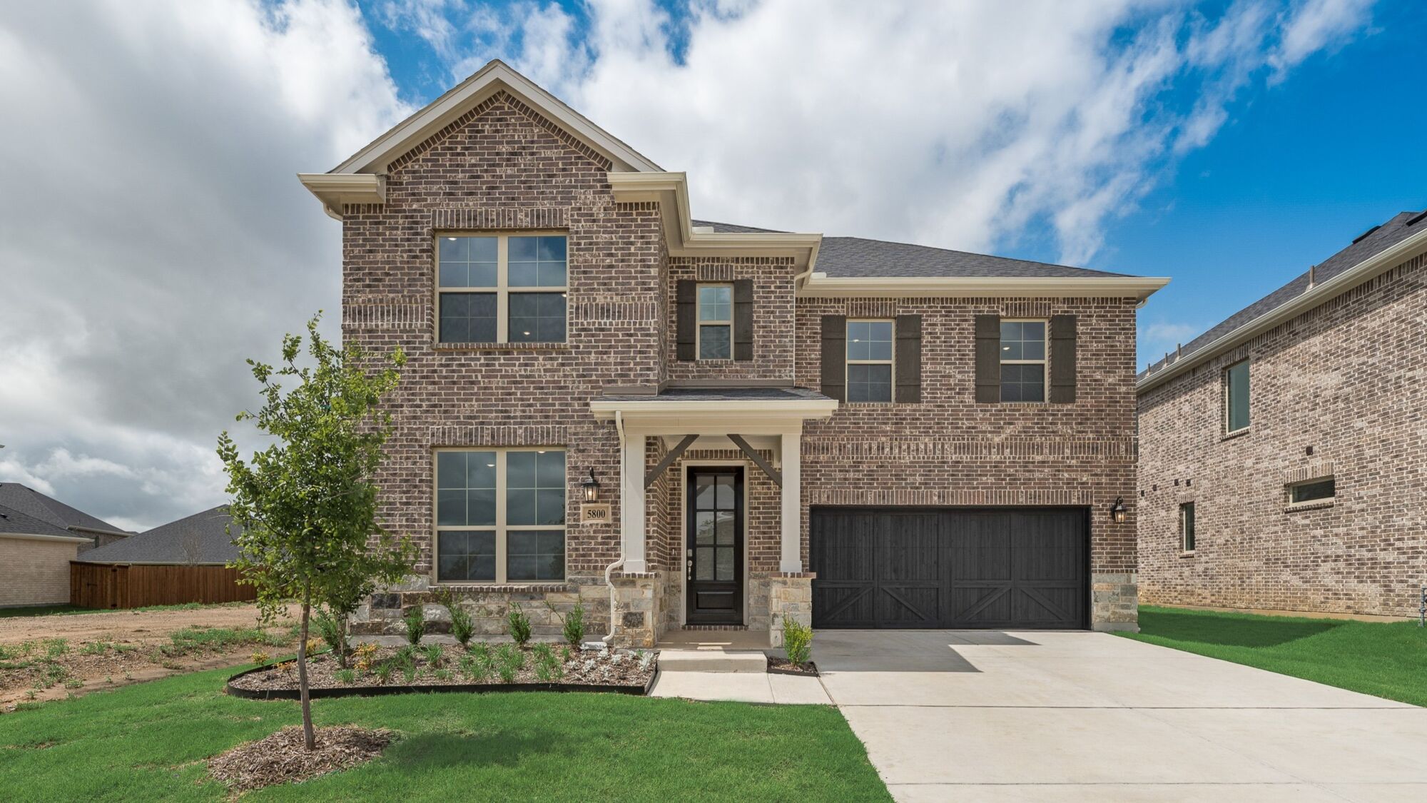 Elevation Front with window, garage, door, exterior brick and exterior stone