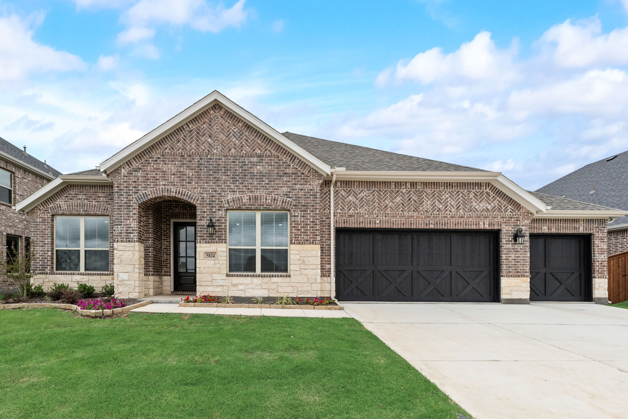 Elevation Front with garage, window, door, exterior stone and exterior brick