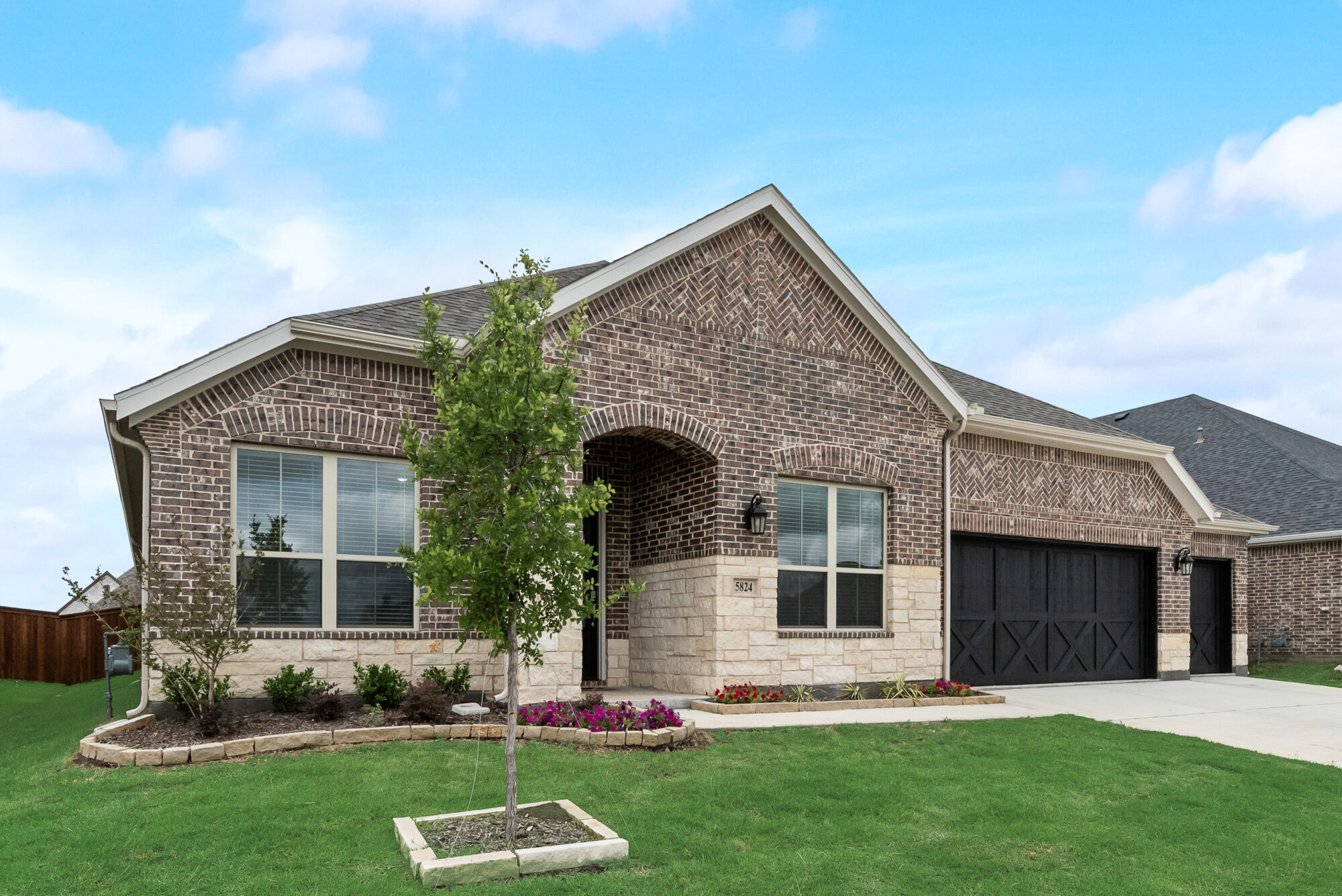Elevation Front with garage, window, exterior stone and exterior brick