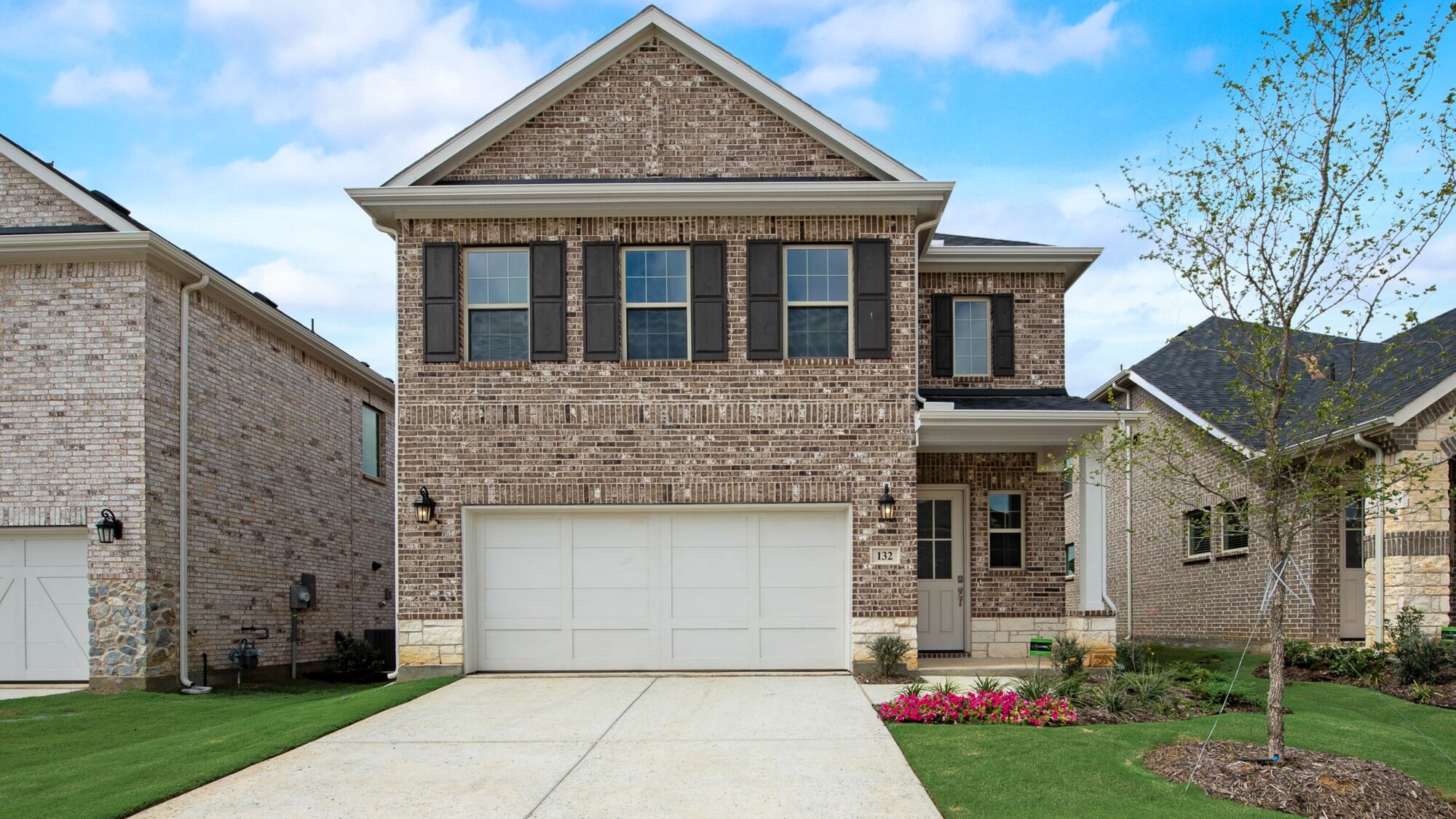 Elevation Front with garage, window, door and exterior brick