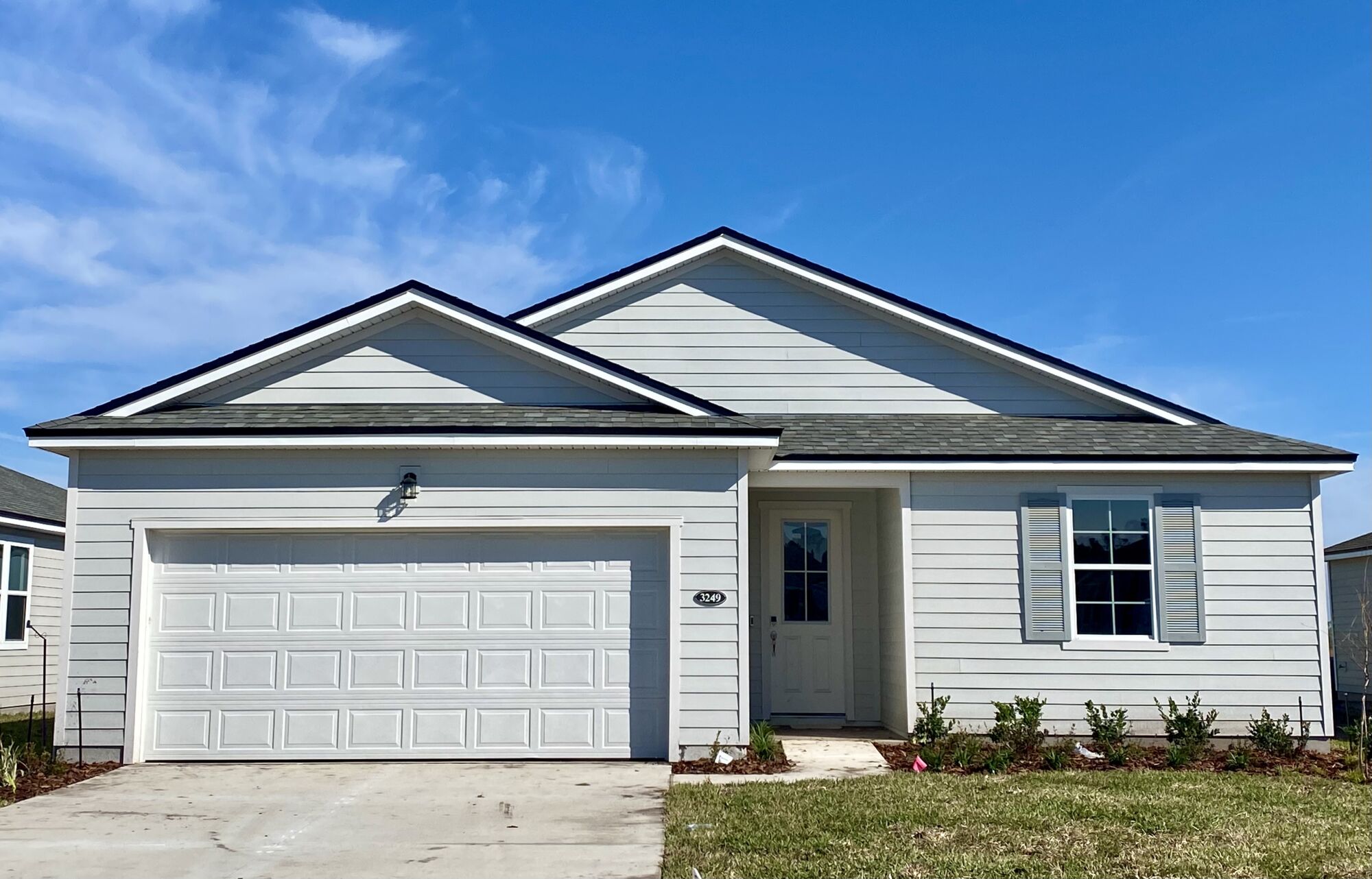  Elevation Front with garage, window, door and exterior clapboard
