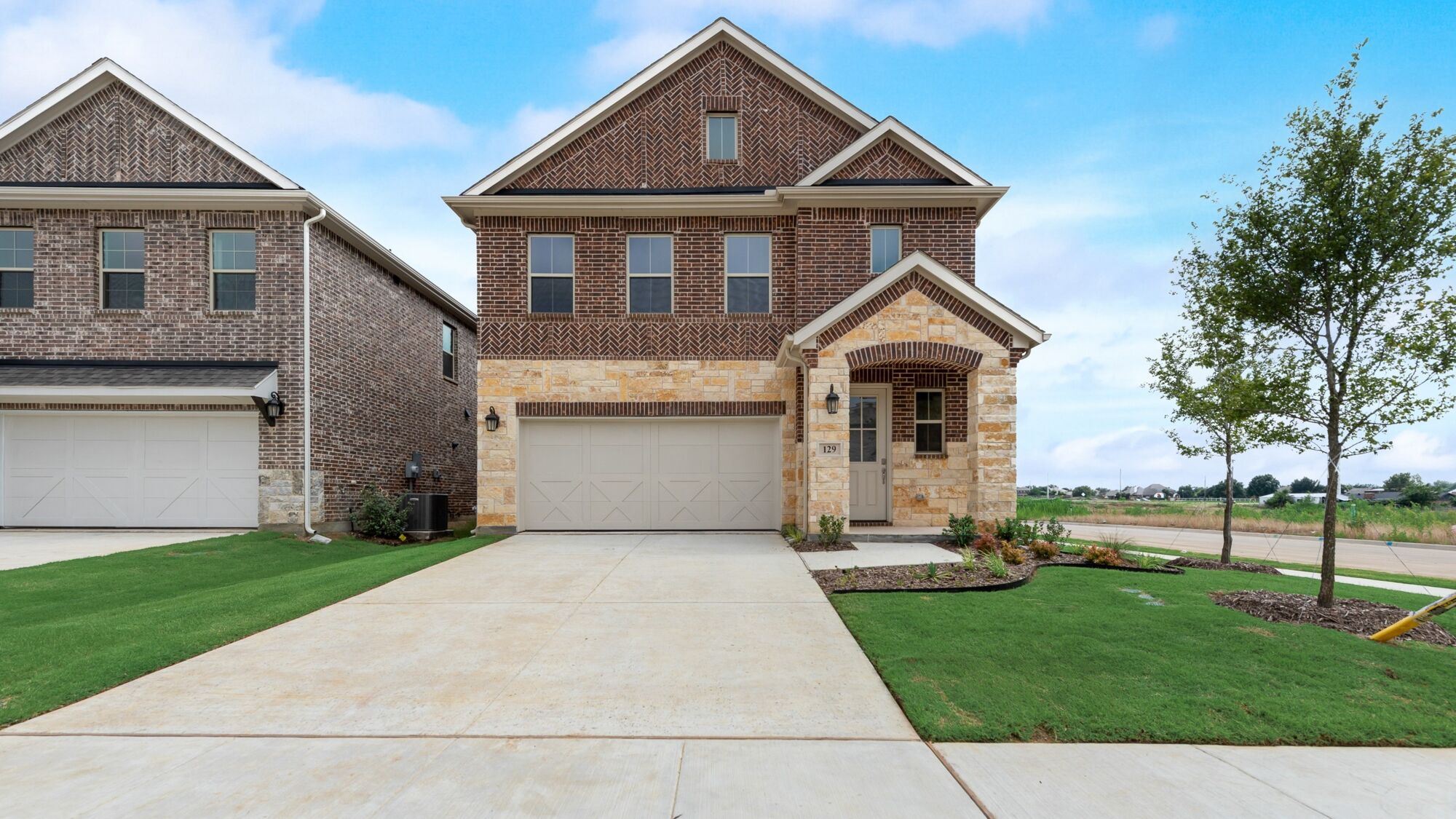 Elevation Front with garage, window, door, exterior brick and exterior stone