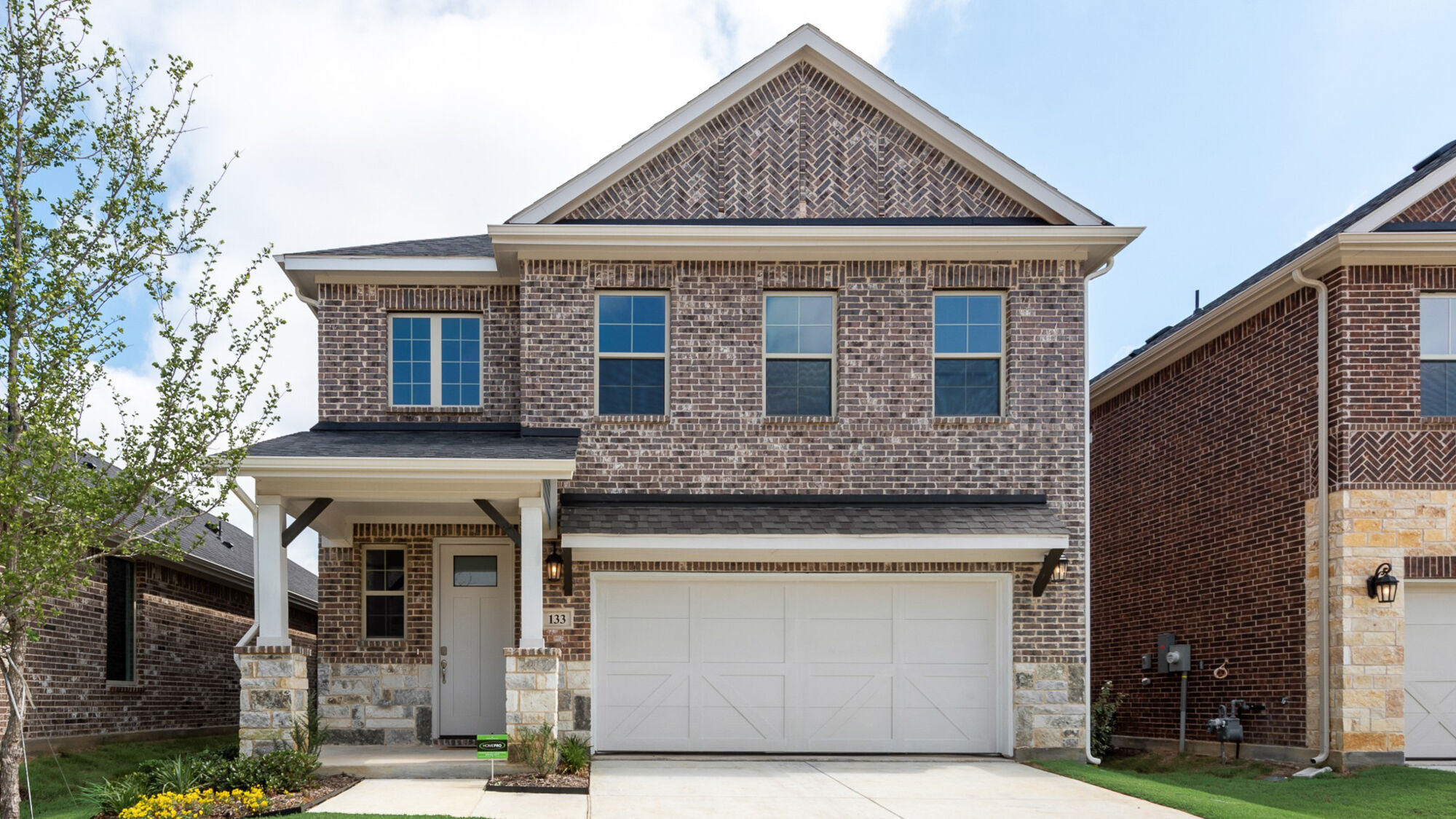 Elevation Front with window, garage, door, exterior stone and exterior brick