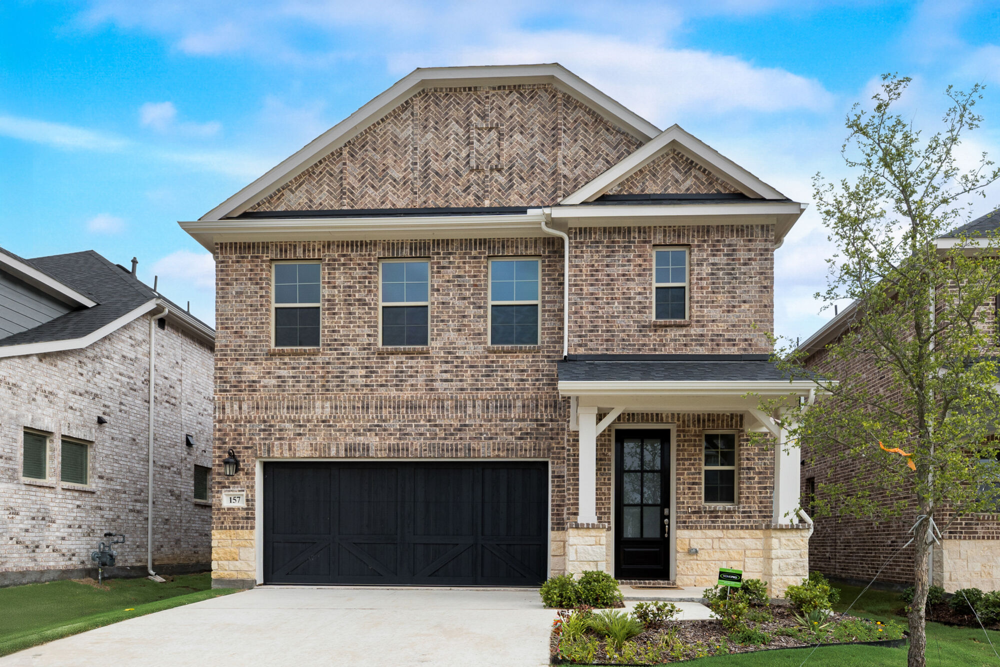 Elevation Front with window, garage, door and exterior brick