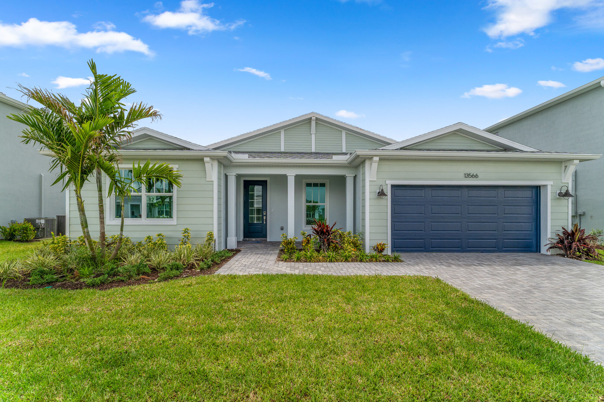 Exterior one story home with lush landscaping