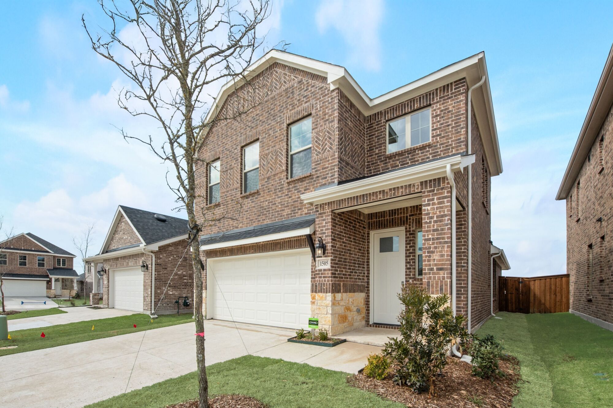 Elevation Front with garage, window, door and exterior brick