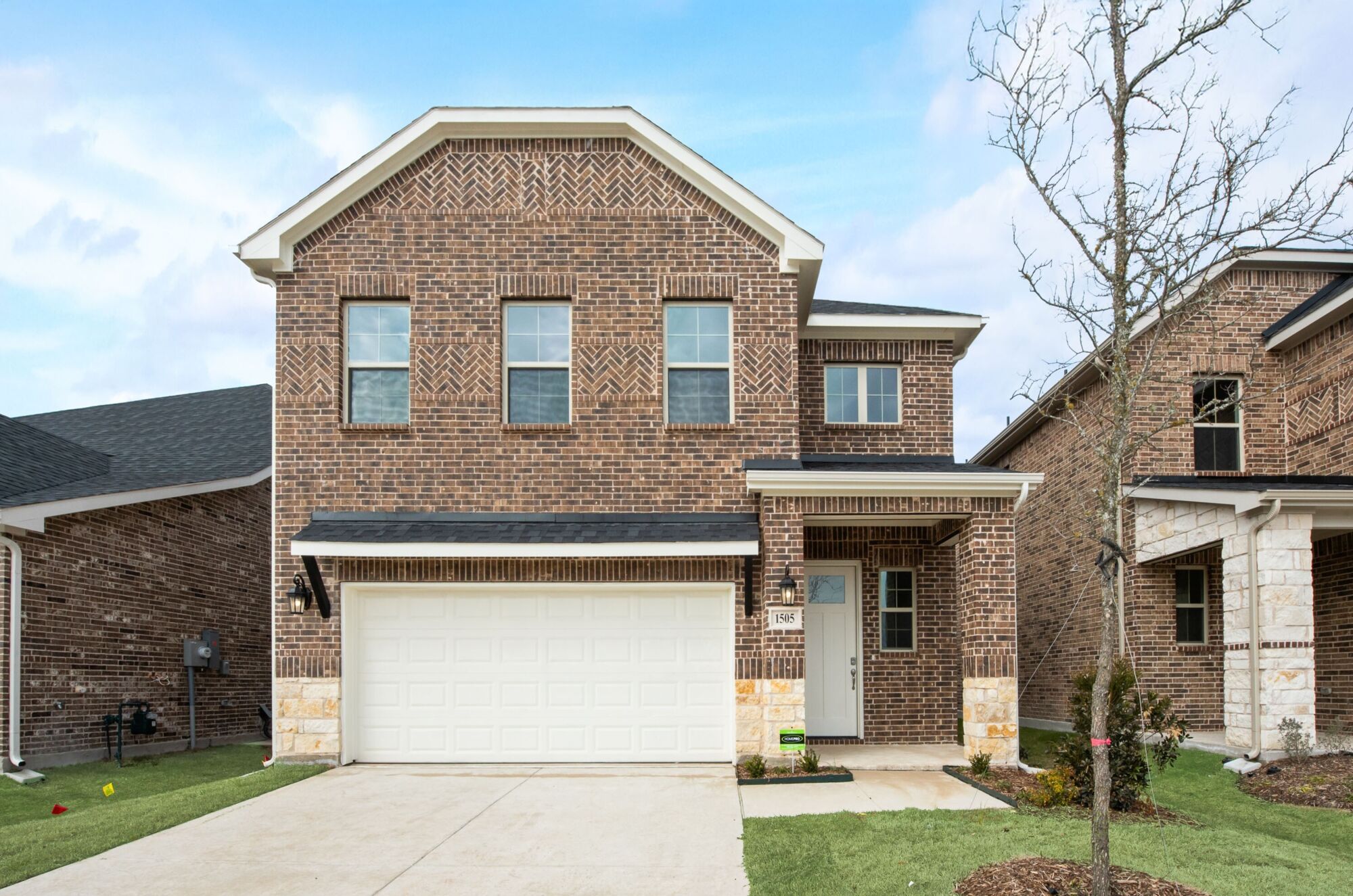 Elevation Front with window, garage, door, exterior brick and exterior stone