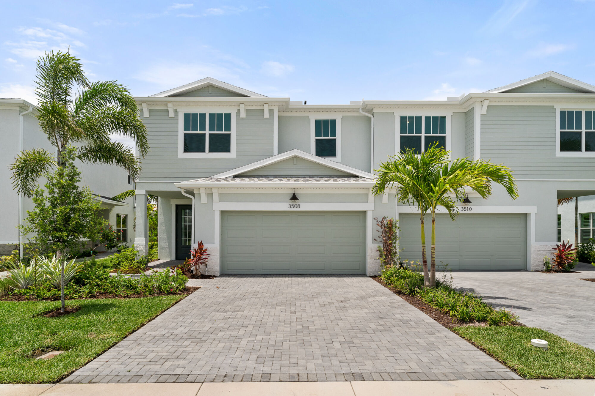Coastal home exterior with lush landscaping