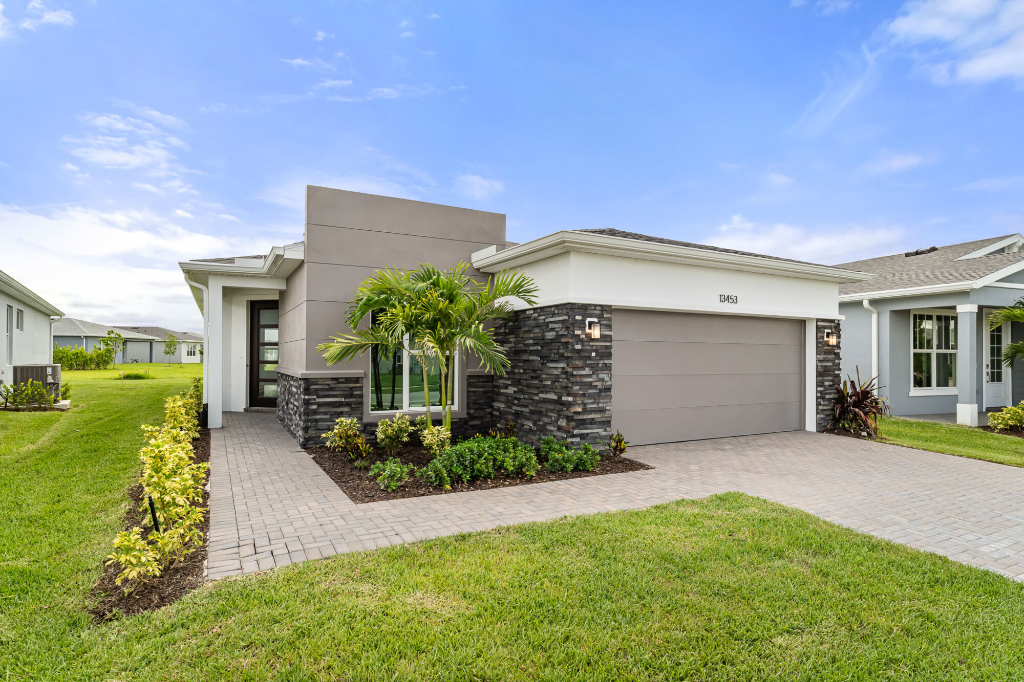  Elevation Front with garage, window, door and exterior stone