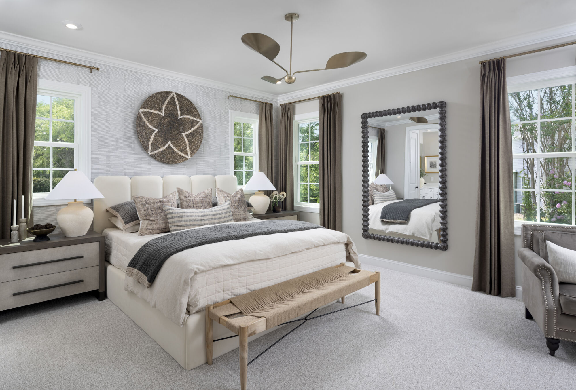 Owners Suite Bedroom with mirror, window, curtains and carpet