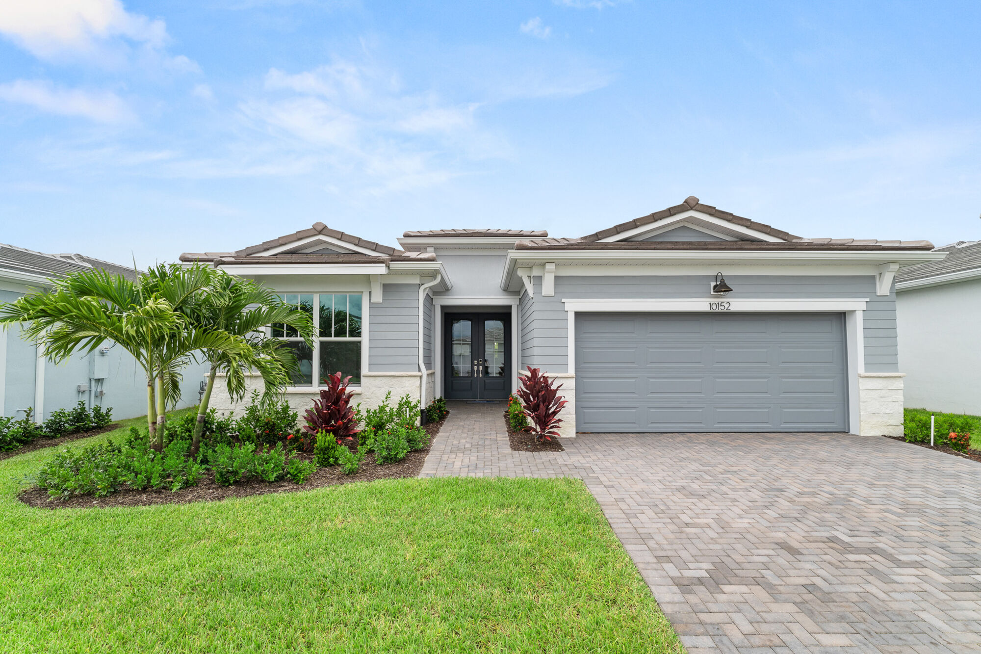  Elevation Front with garage, door, window and exterior stone