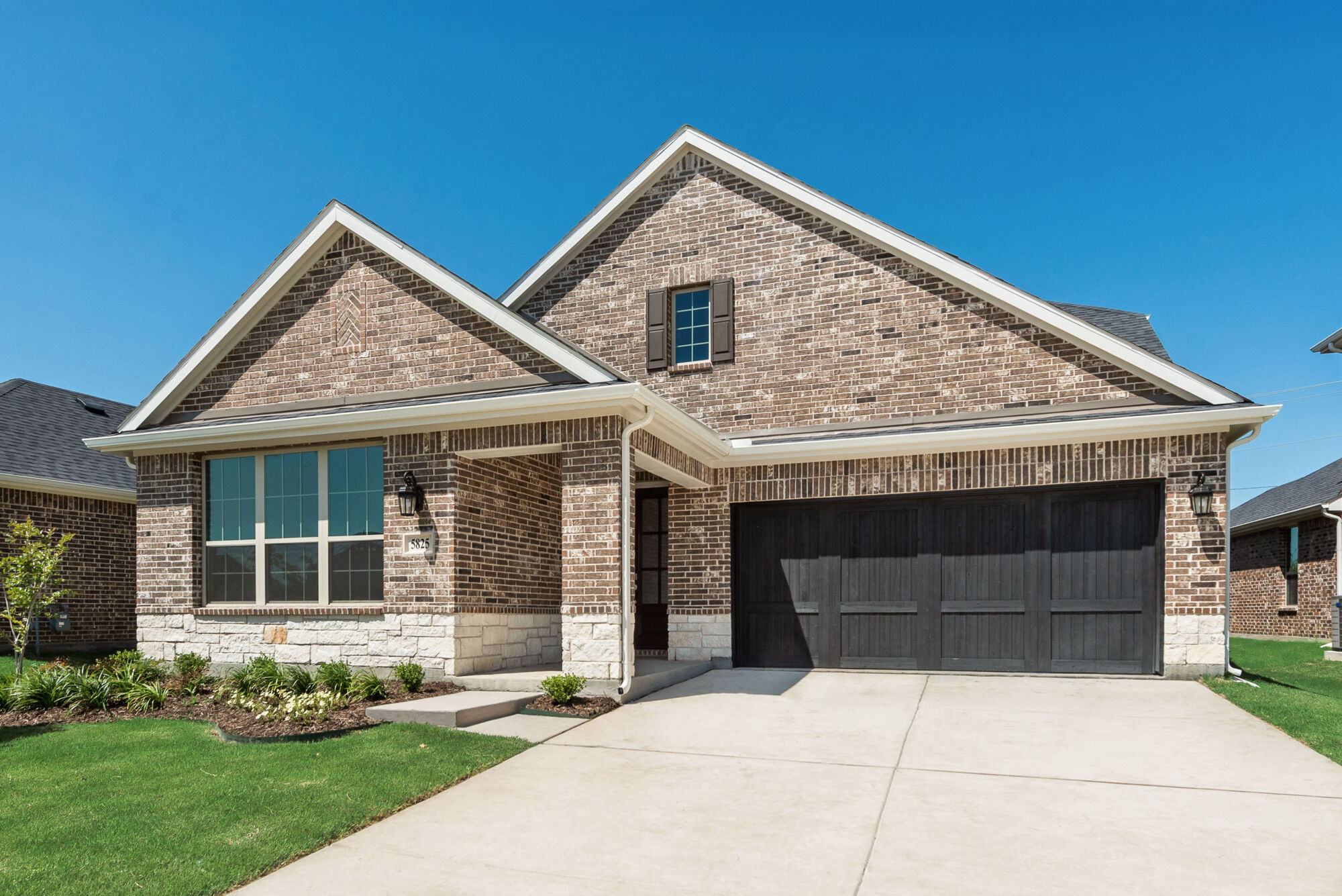 Elevation Front with window, garage and exterior brick