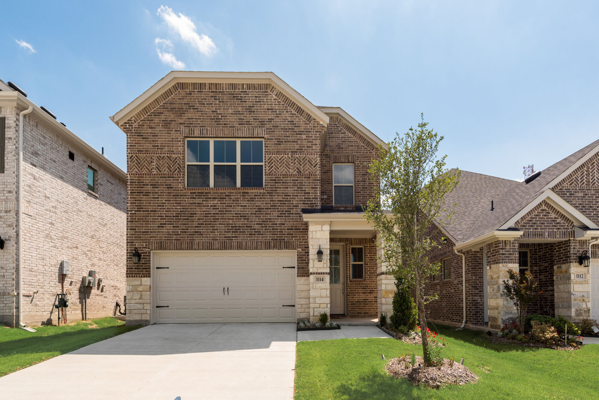 Elevation Front with window, garage, exterior brick and exterior stone
