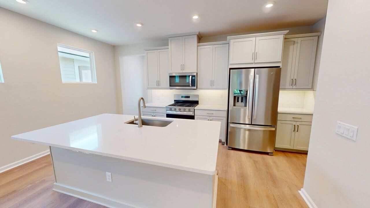 Single-Wall Kitchen with window, refrigerator, white cabinets, range, raised panel cabinets and wood flooring