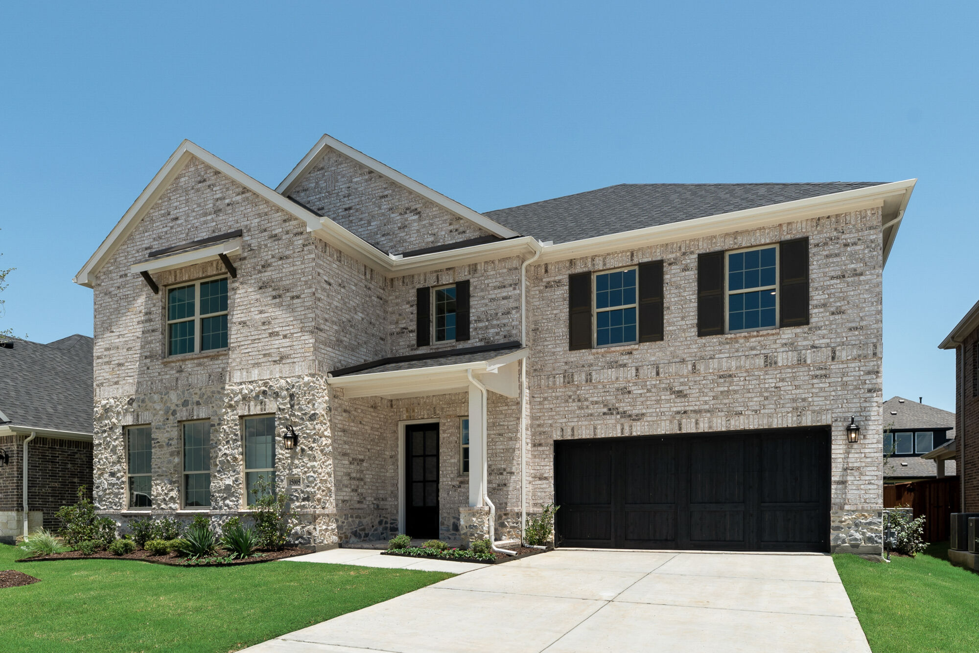 Elevation Front with window, garage, exterior brick and exterior stone