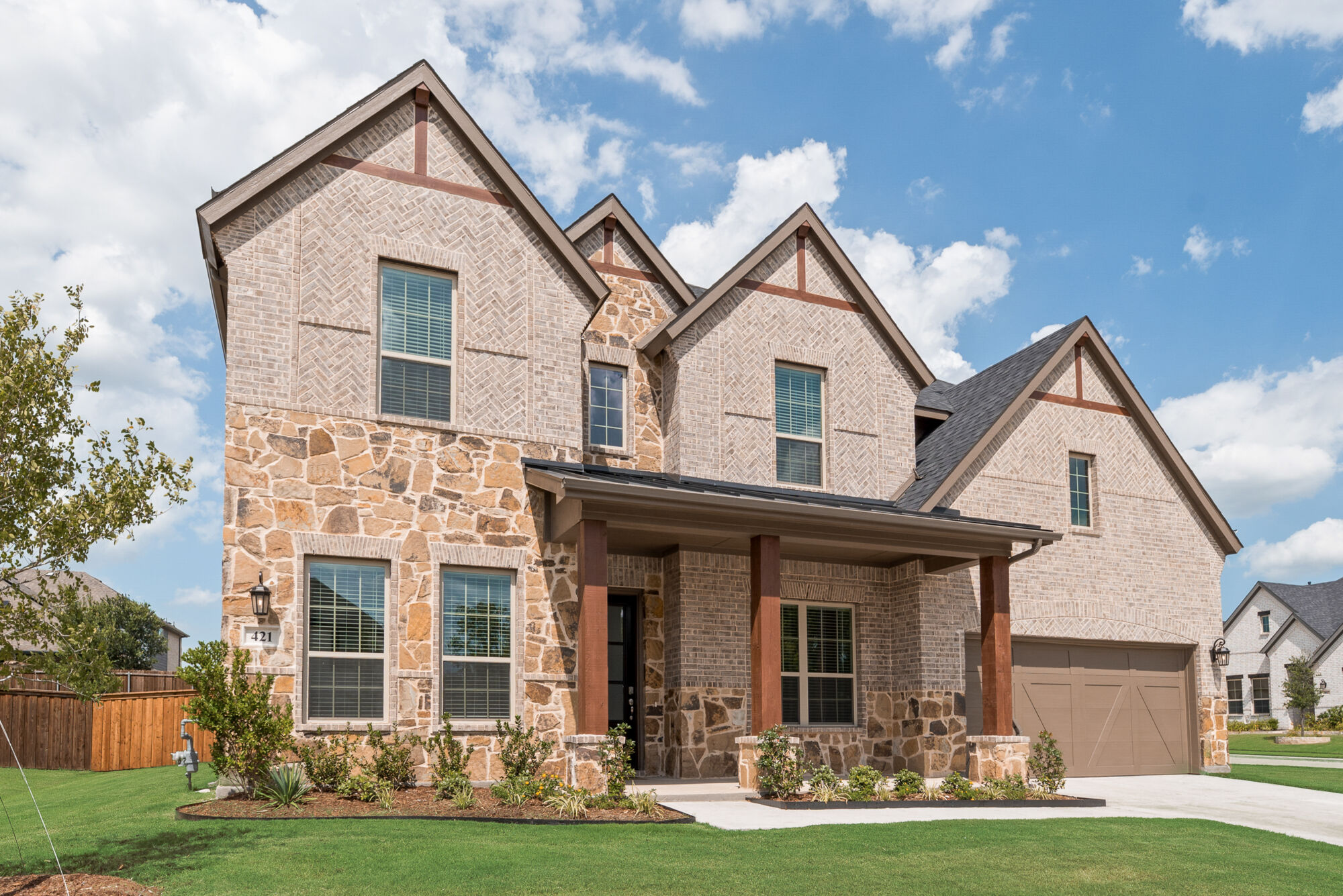 Elevation Front with window, garage, exterior brick and exterior stone