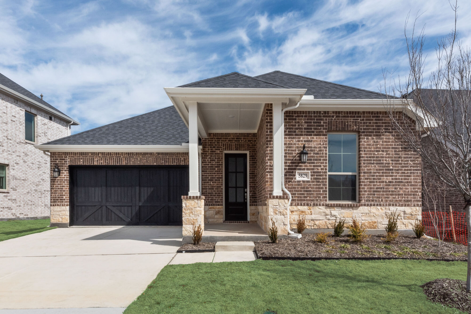 Elevation Front with window, garage, door, exterior brick and exterior stone